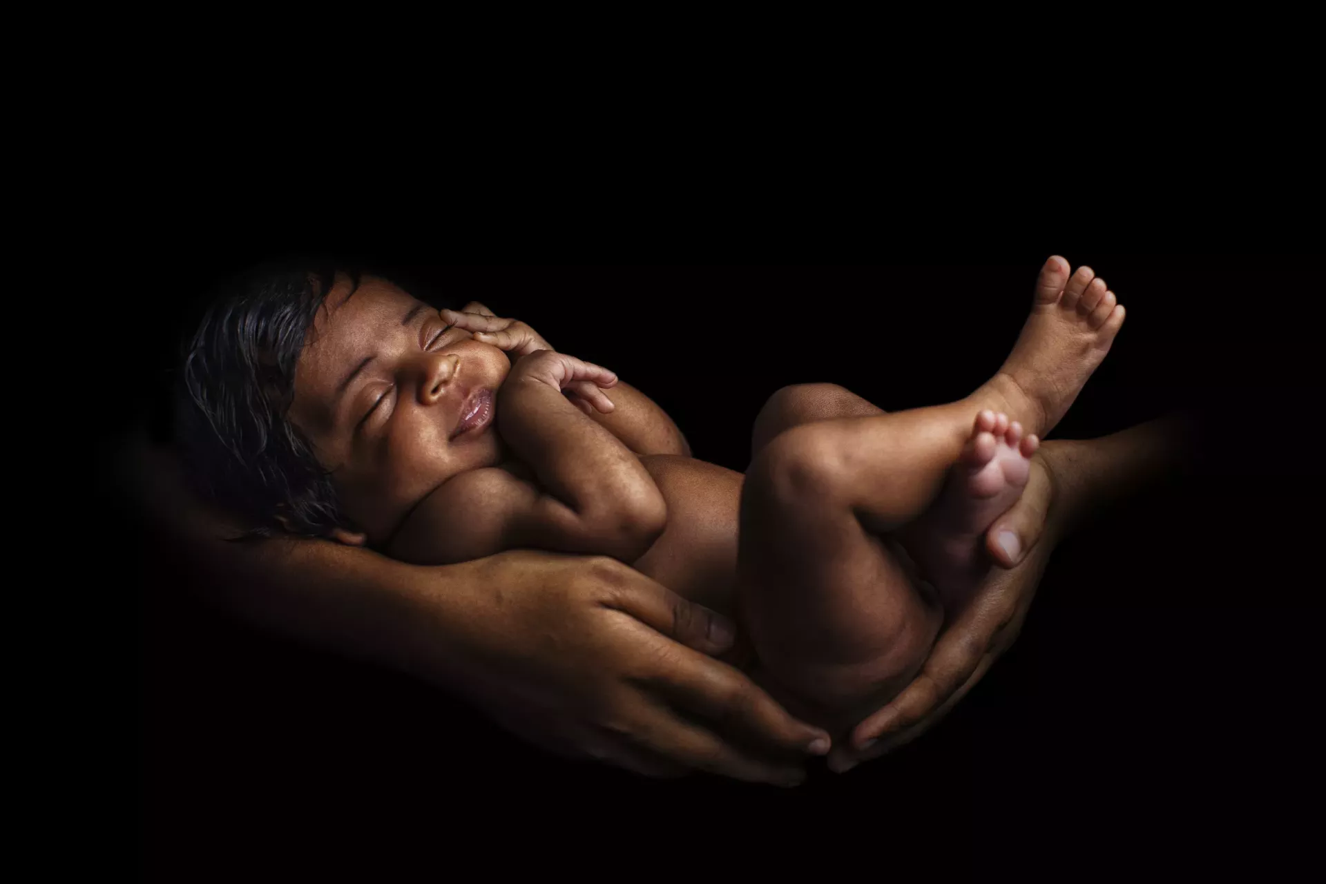 A mother holding her newborn baby