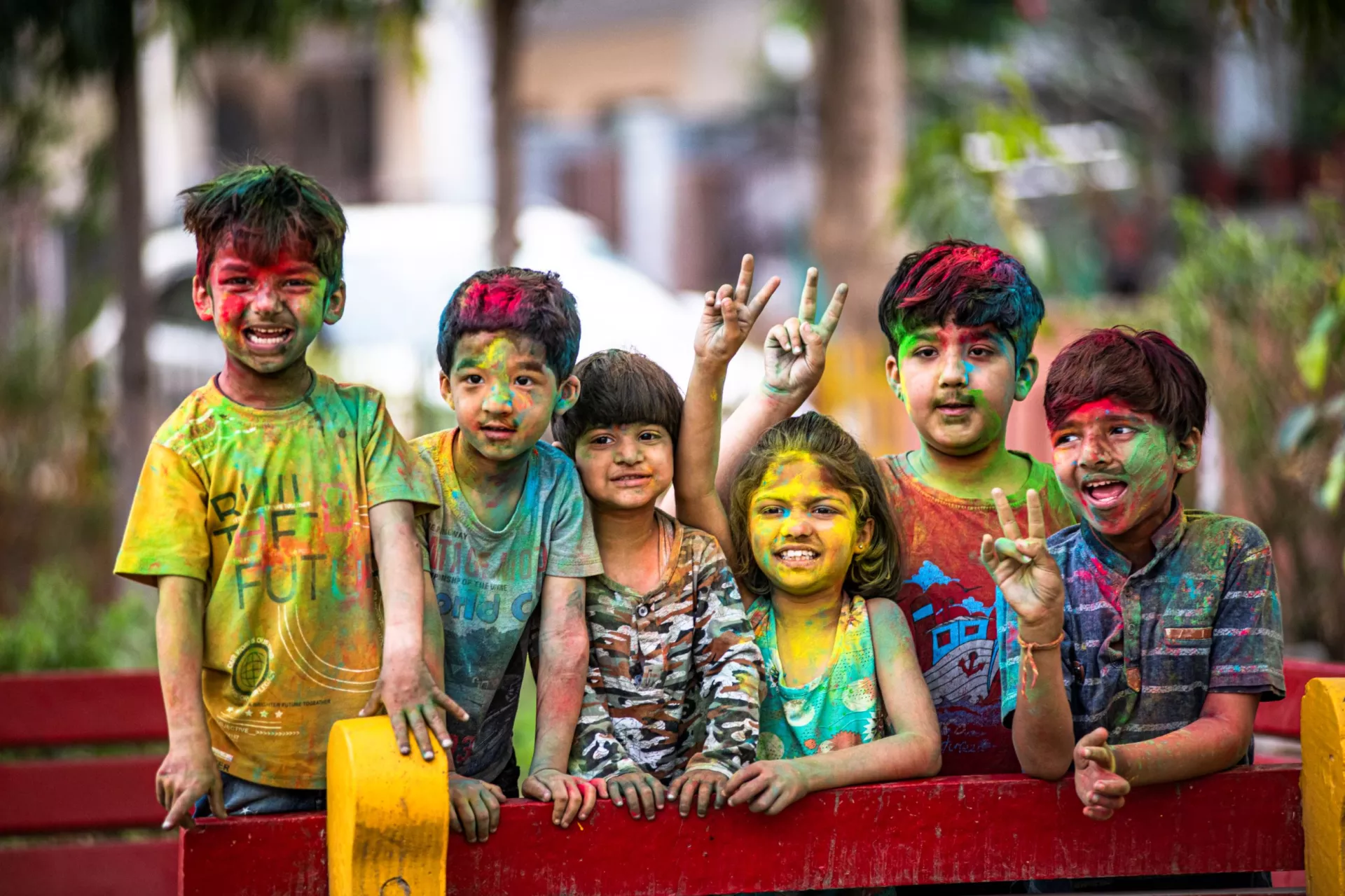 Kids playing with paint colours put all over their bodies and clothes