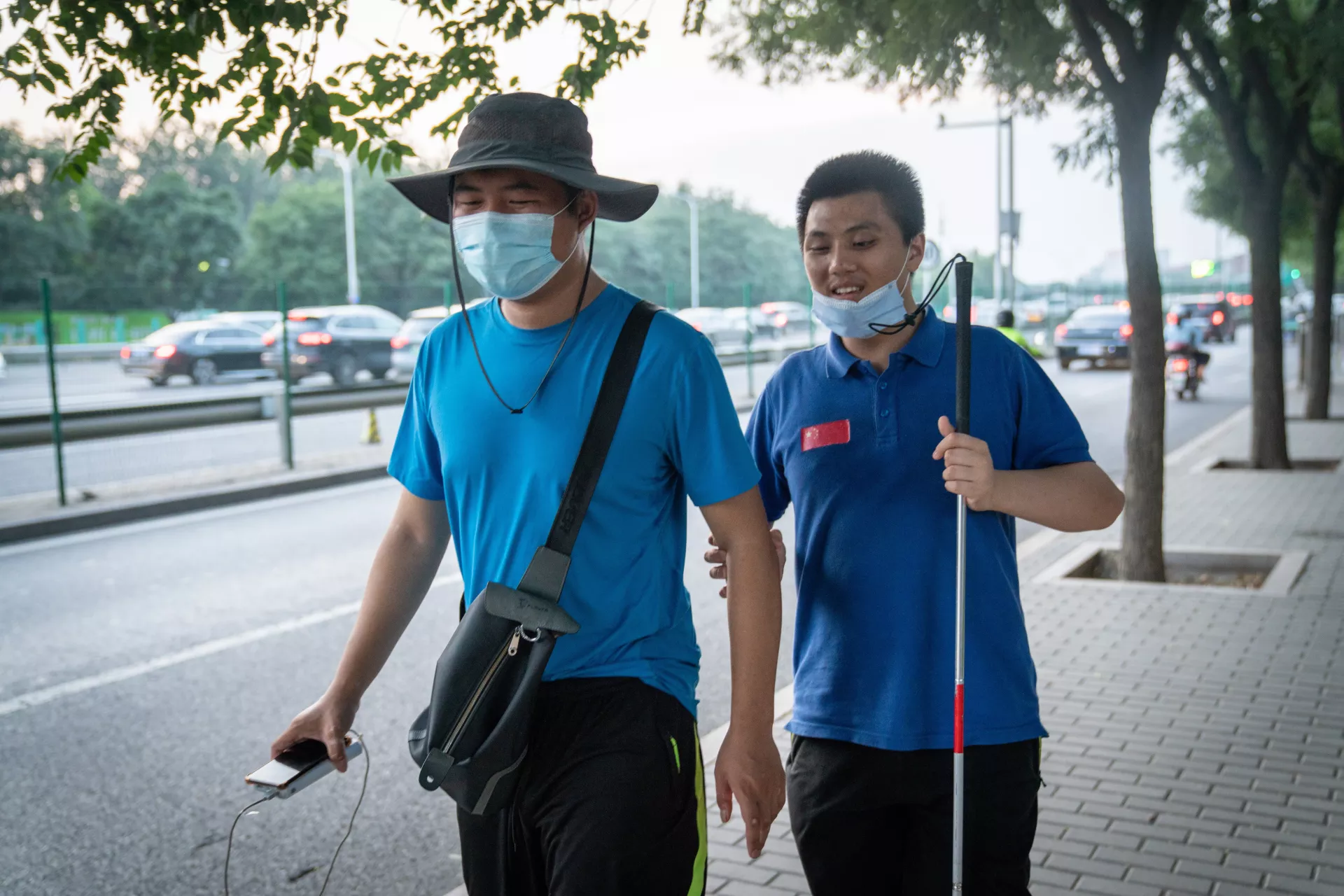Two young boys, friend, walk in Beijin, China