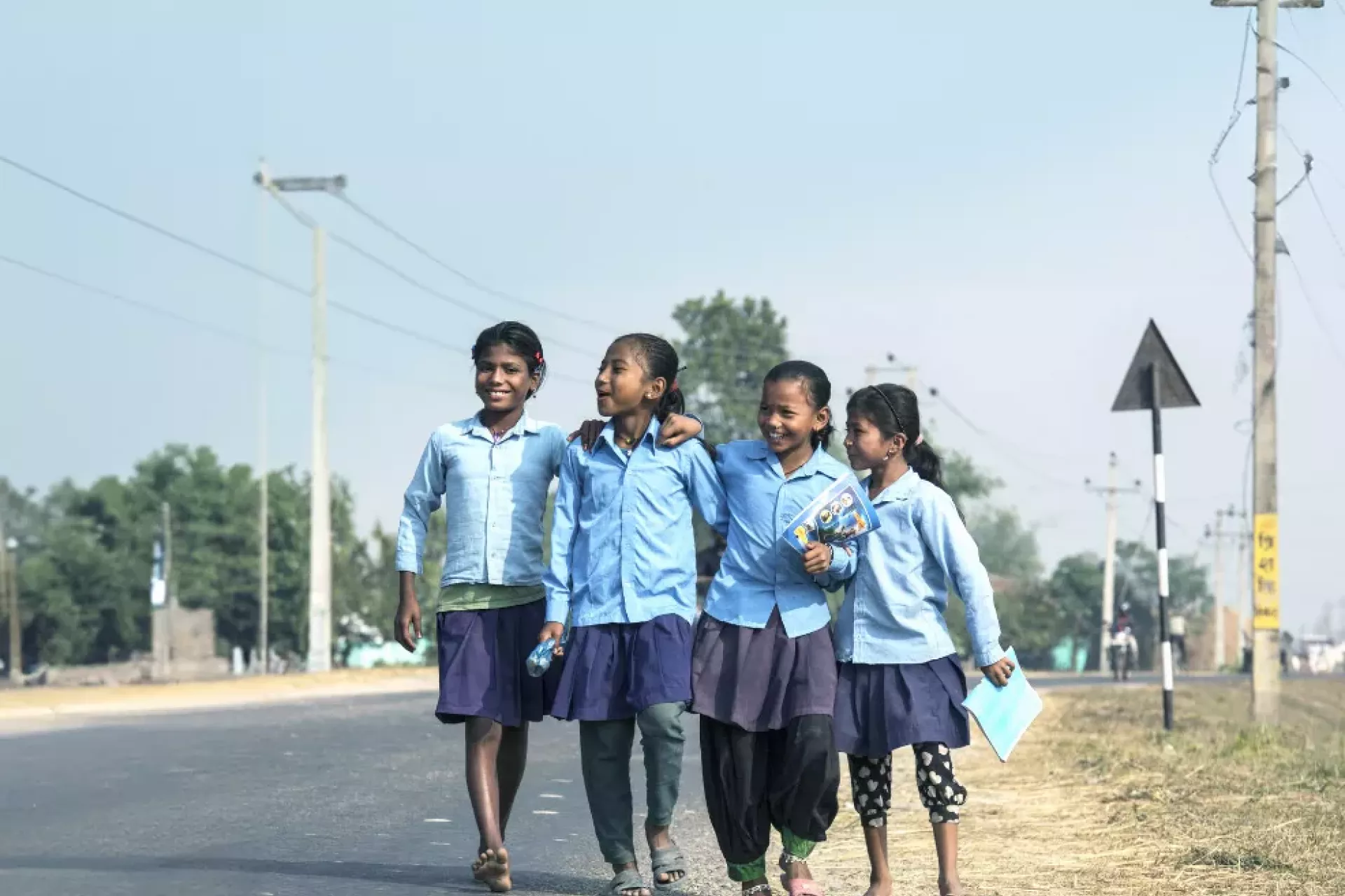 Young schoolgirls walking on the street.