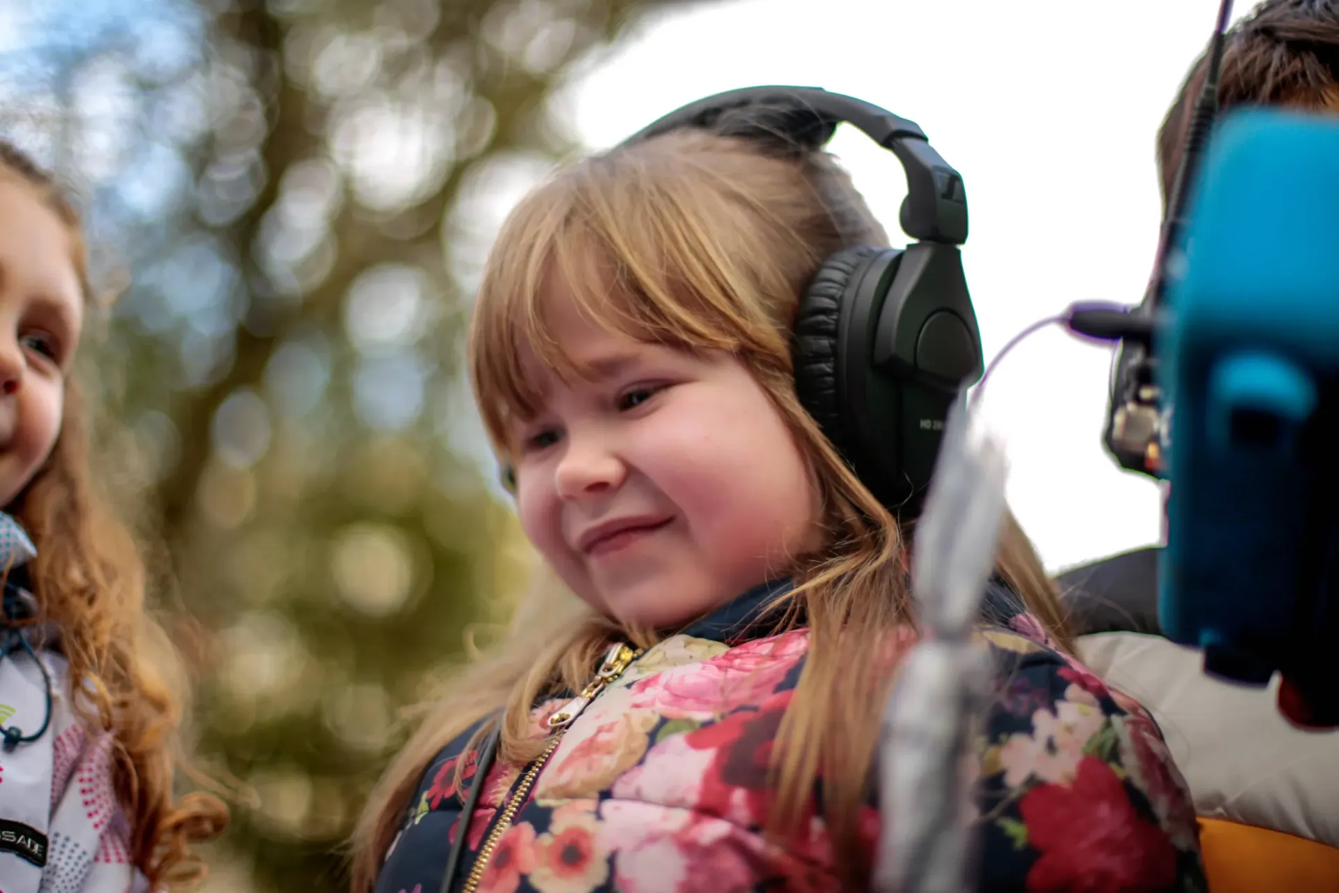 A 8-year-old girl listens carefully and says she hears a "loud noise" in her headphones.