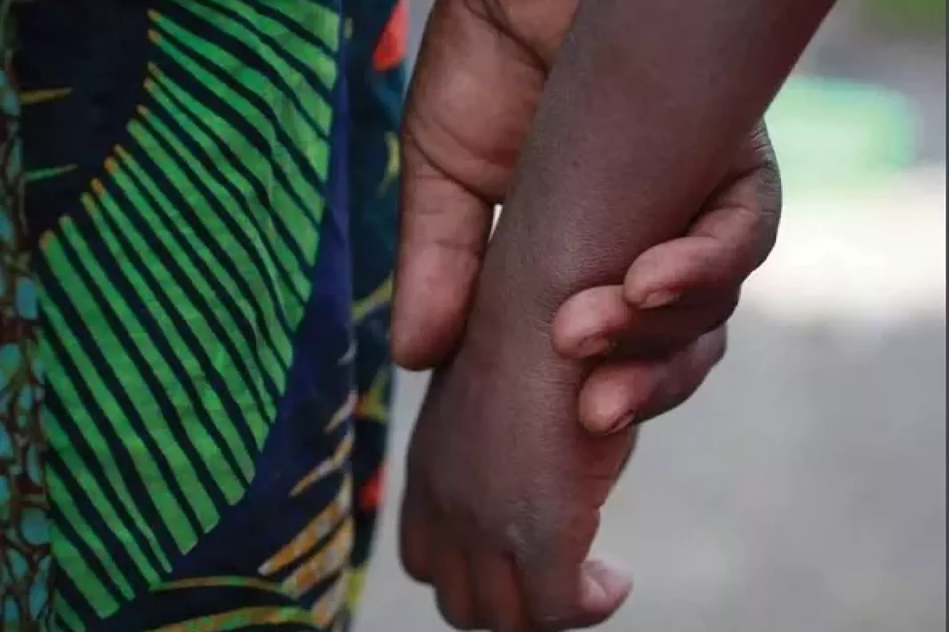 A child hand hold by an adult