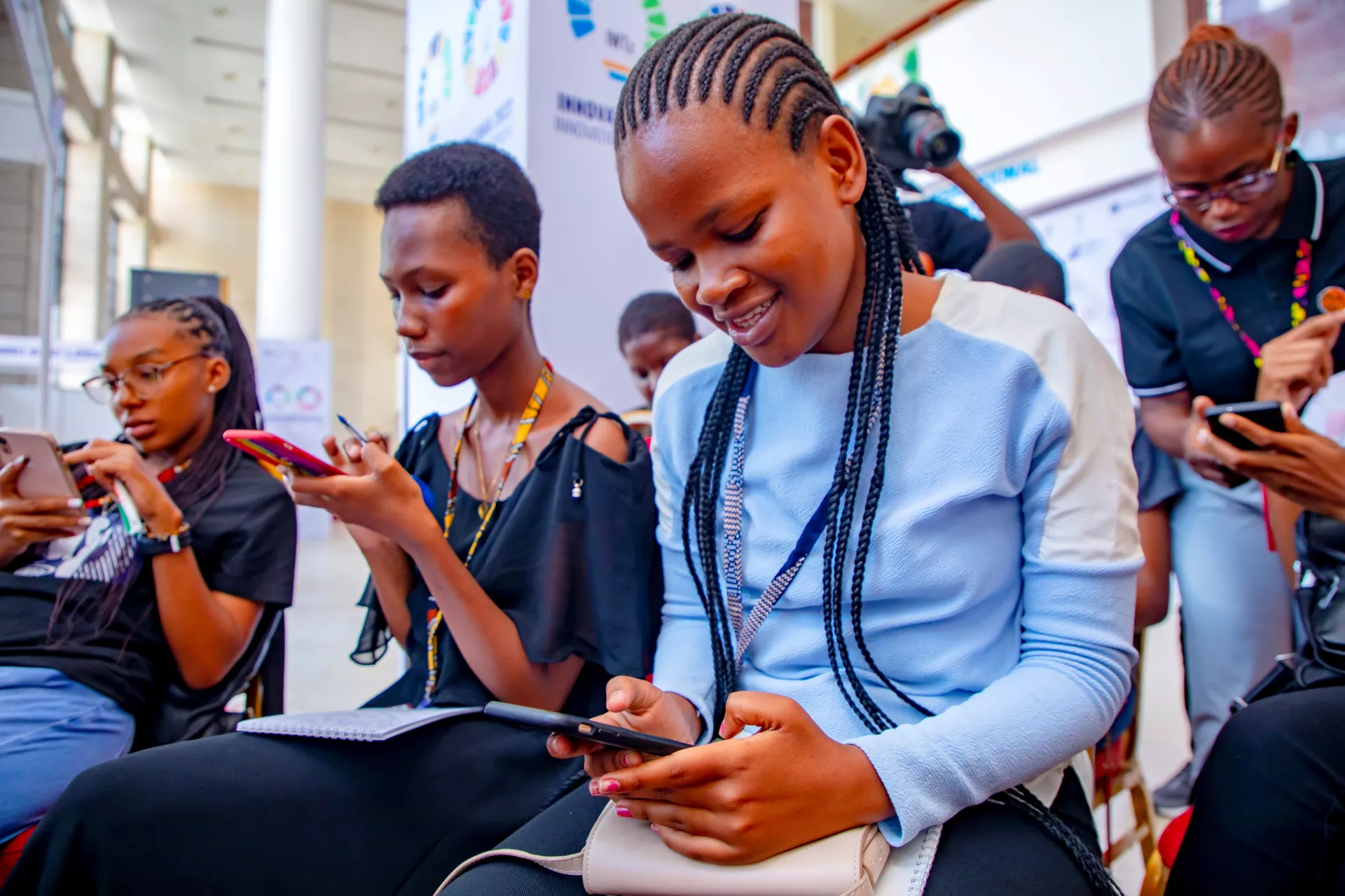 Young girls studying using mobile devices