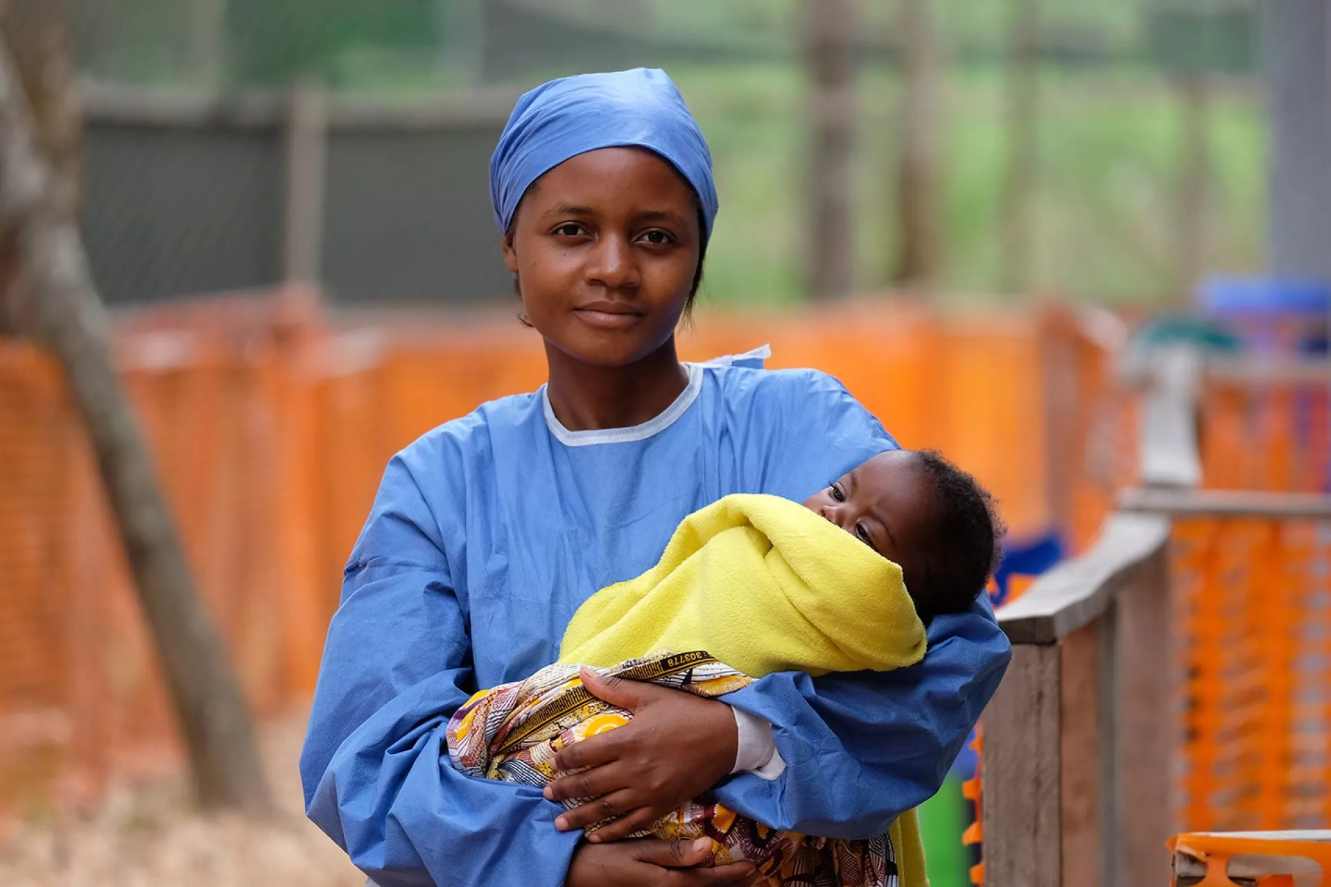 A nurse holding a baby