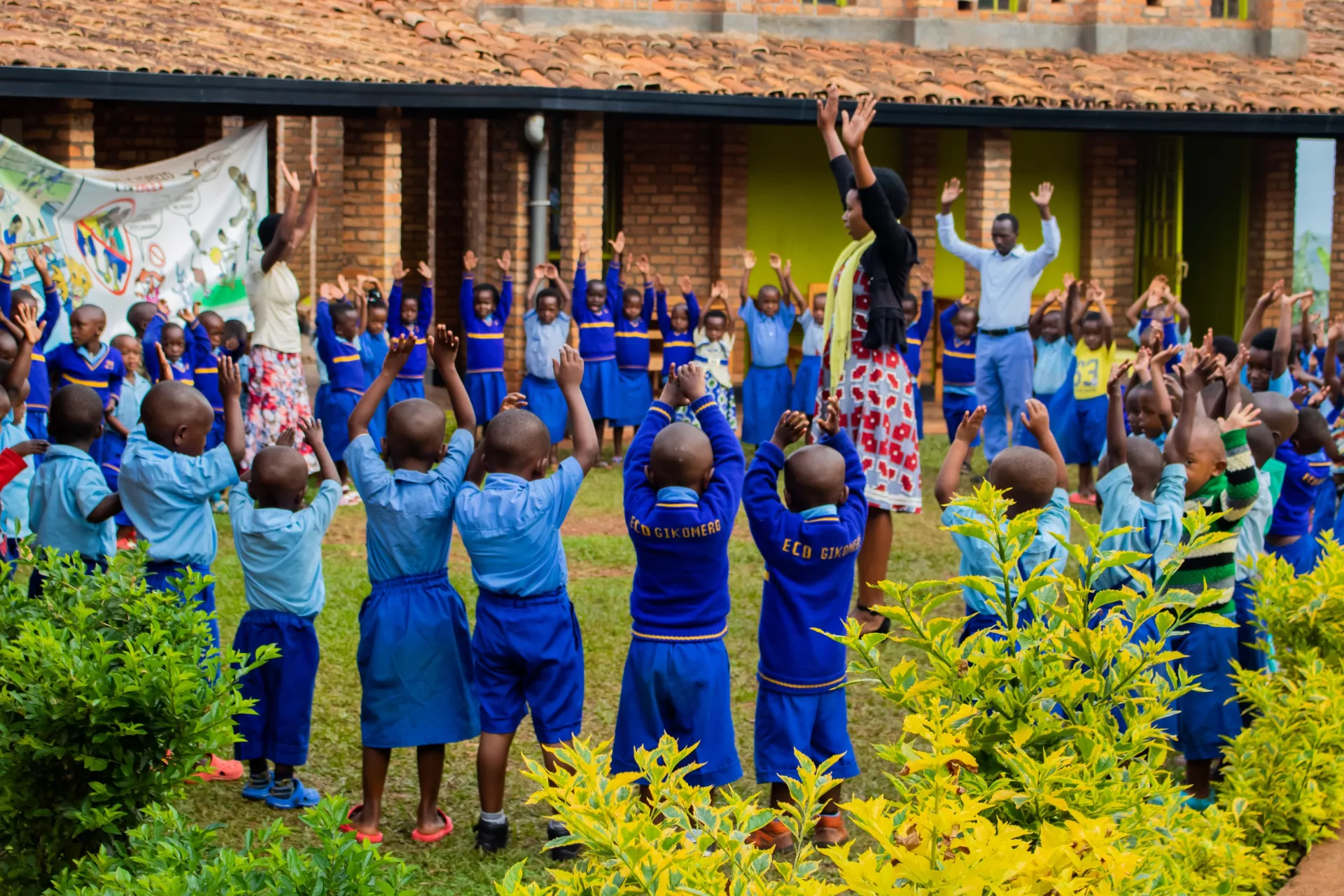 Children at the Gikomero Early Childhood Development Centre play some morning games with their caregivers.