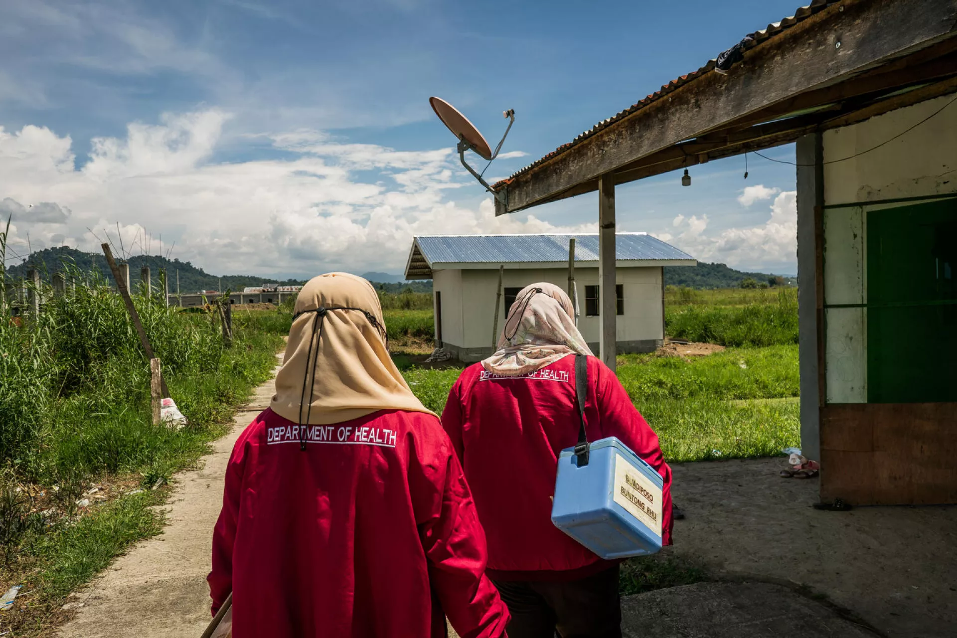 On 22 September 2022 in Buadiposo-Buntong BARMM, Philippines, Health Workers Ash Abubacar and Injilah Moca, go house-to-house in the communities covered by their rural health unit to offer vaccines to those unable to visit the health center.
