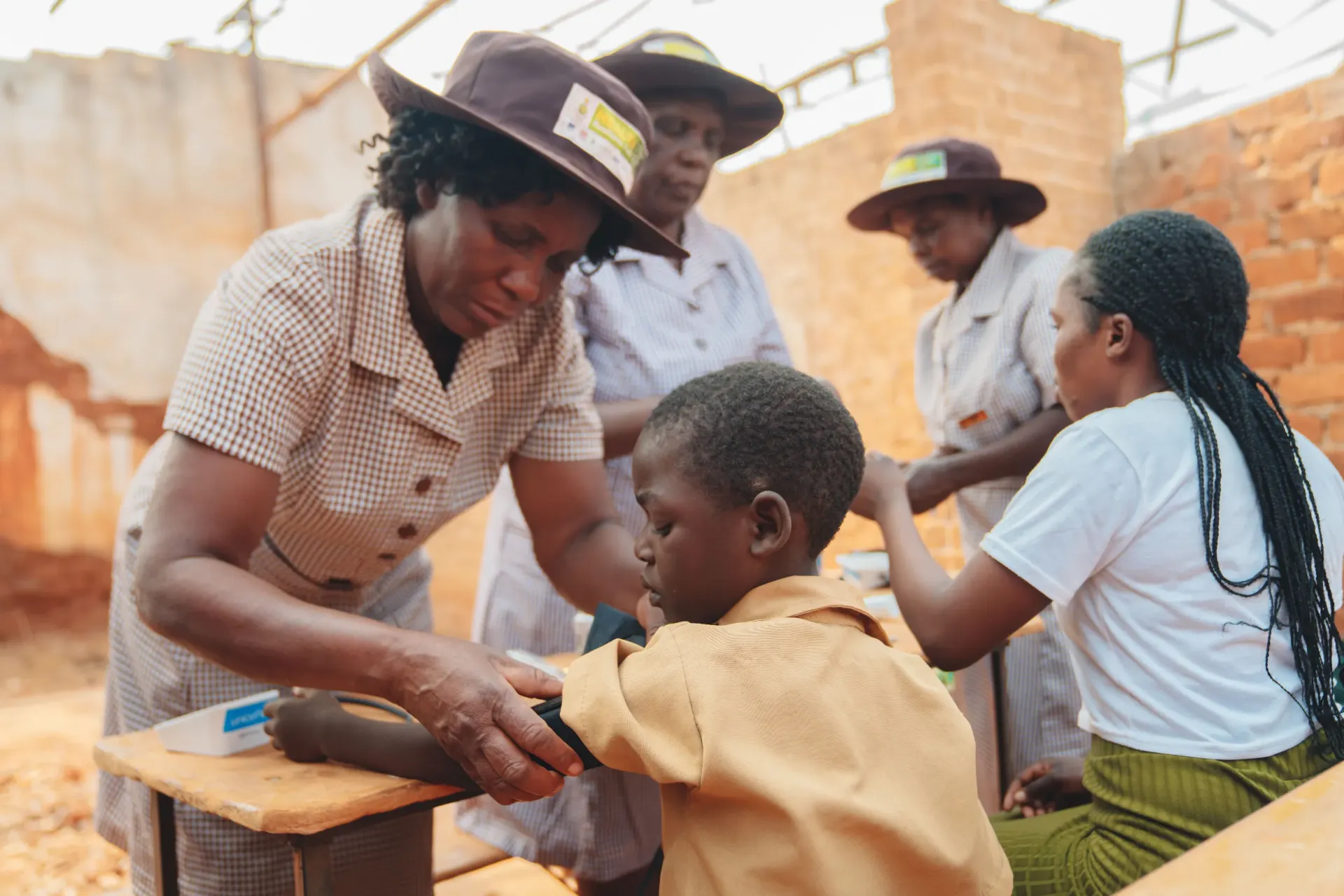 A Village Health Worker checks the vitals of a young patient at Luwana, Zimbabwe, where UNICEF and Eli Lilly are working together to improve non-communicable disease prevention and care for children.