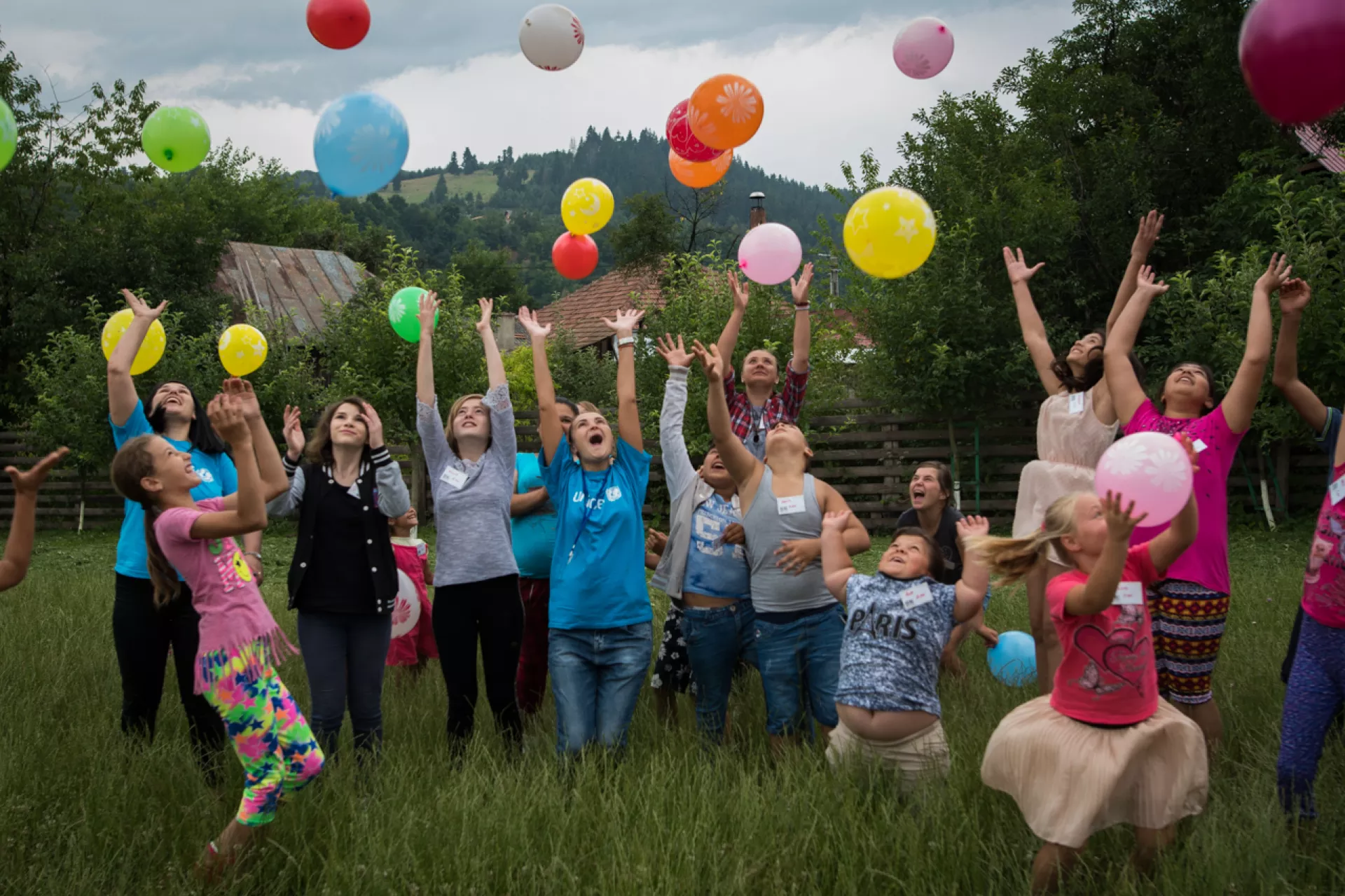 Young children playing and interacting with UNICEF staff and social workers at Dofteana Community center, in Bacu County, Romania.