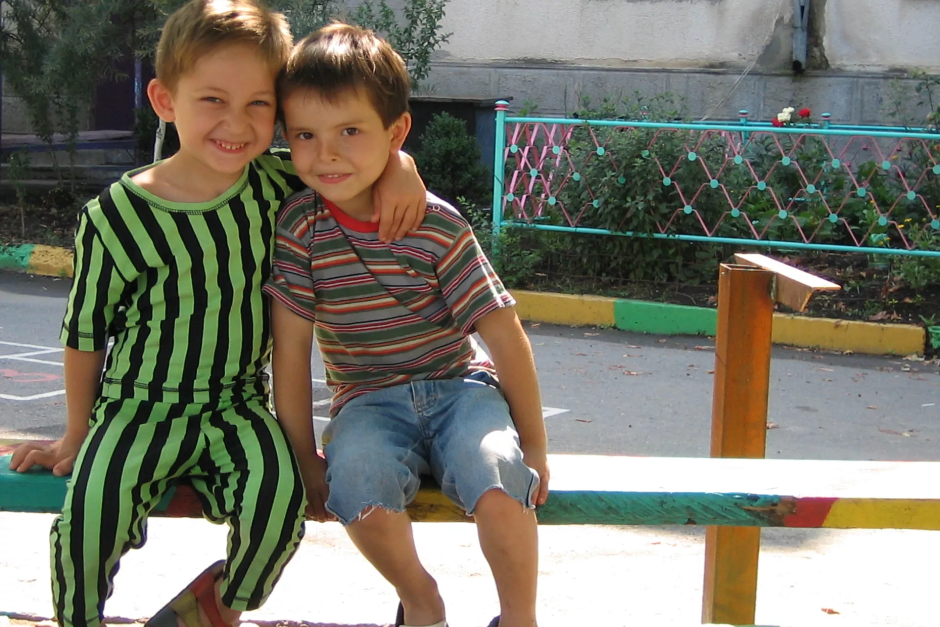 wo boys smile, one with his arm around the other, in the town of Beslan, Russia Federation.