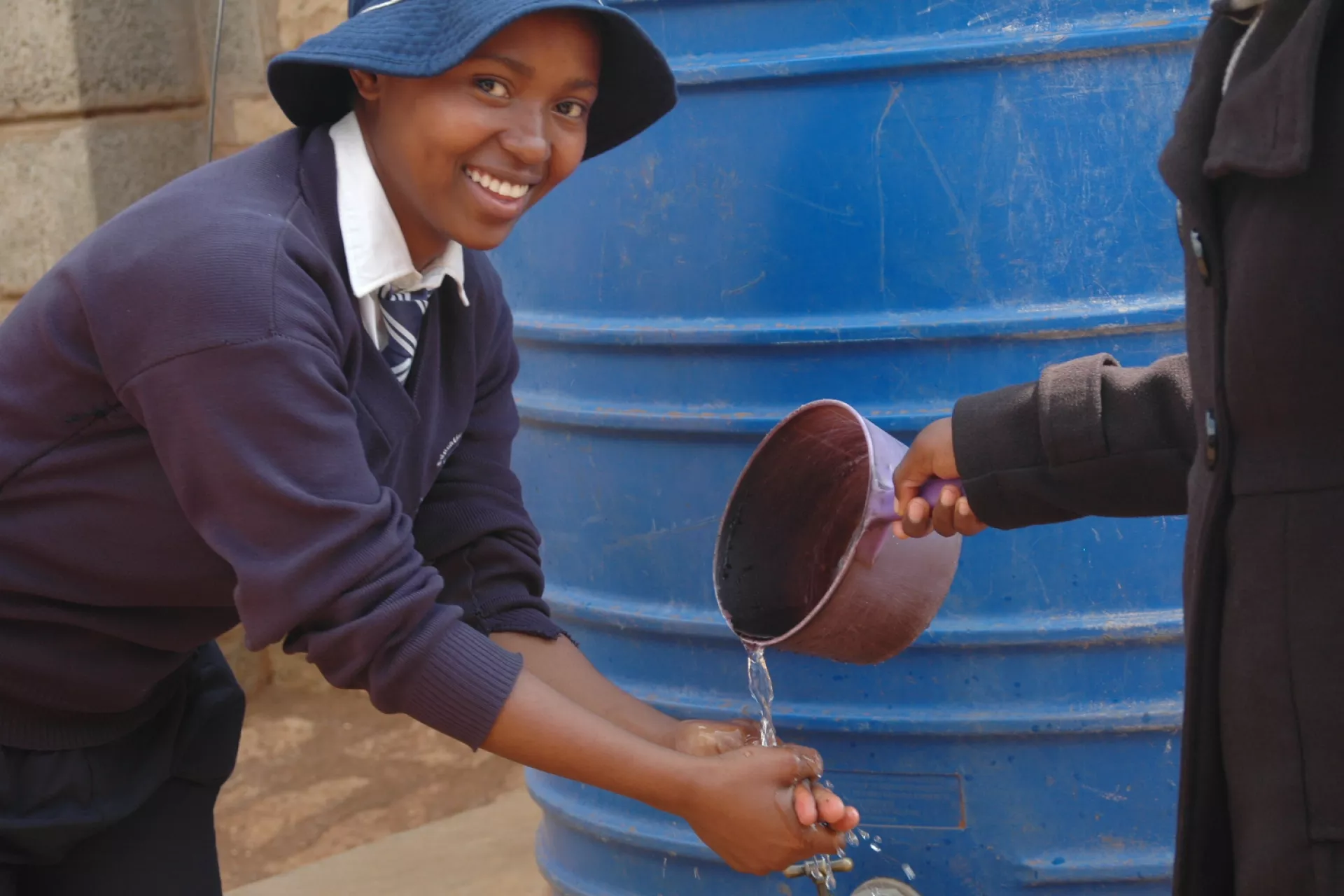 Sixteen-year-old Selina Mokoena washes her hands 