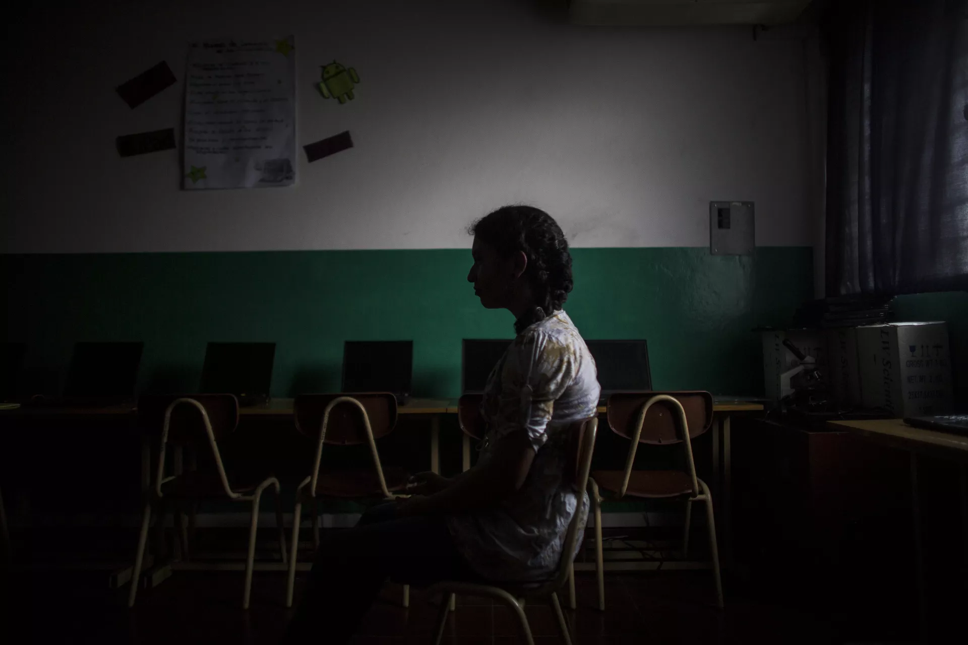 A girl sits in a classroom, El Salvador