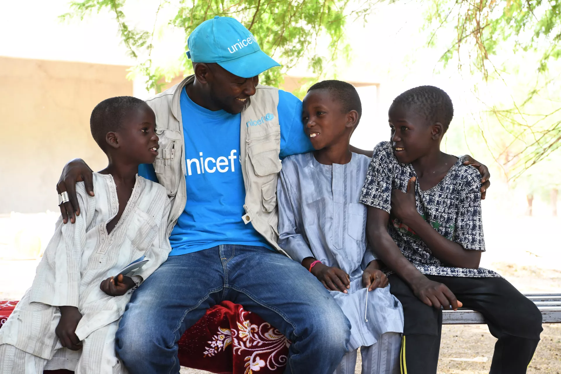 Children with a UNICEF Staff member in the village of Zermou, in the center of Niger. 