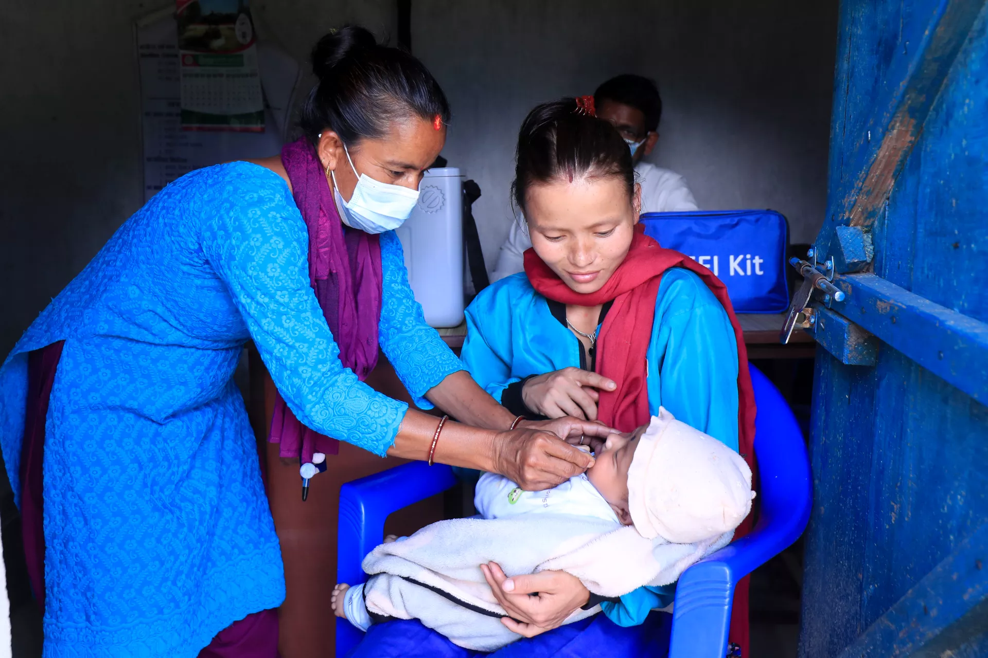 At a vaccine outreach session in a community in the Jorayal Rural Municipality in Doti District in Nepal&rsquo;s far west, health worker Basanta Malla administers vaccines to three-month-old Rhythm.