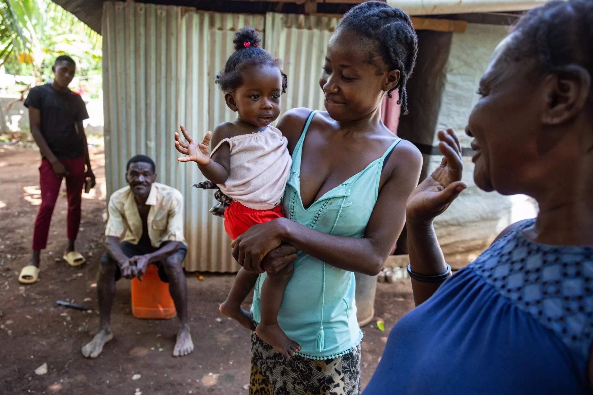On 19 July 2022 in the village of Troirac near the town of Camp Perrin in Haiti, mother Camsus Joseph holds her 9-month-old daughter, Anne Djouna&iuml;ka. 