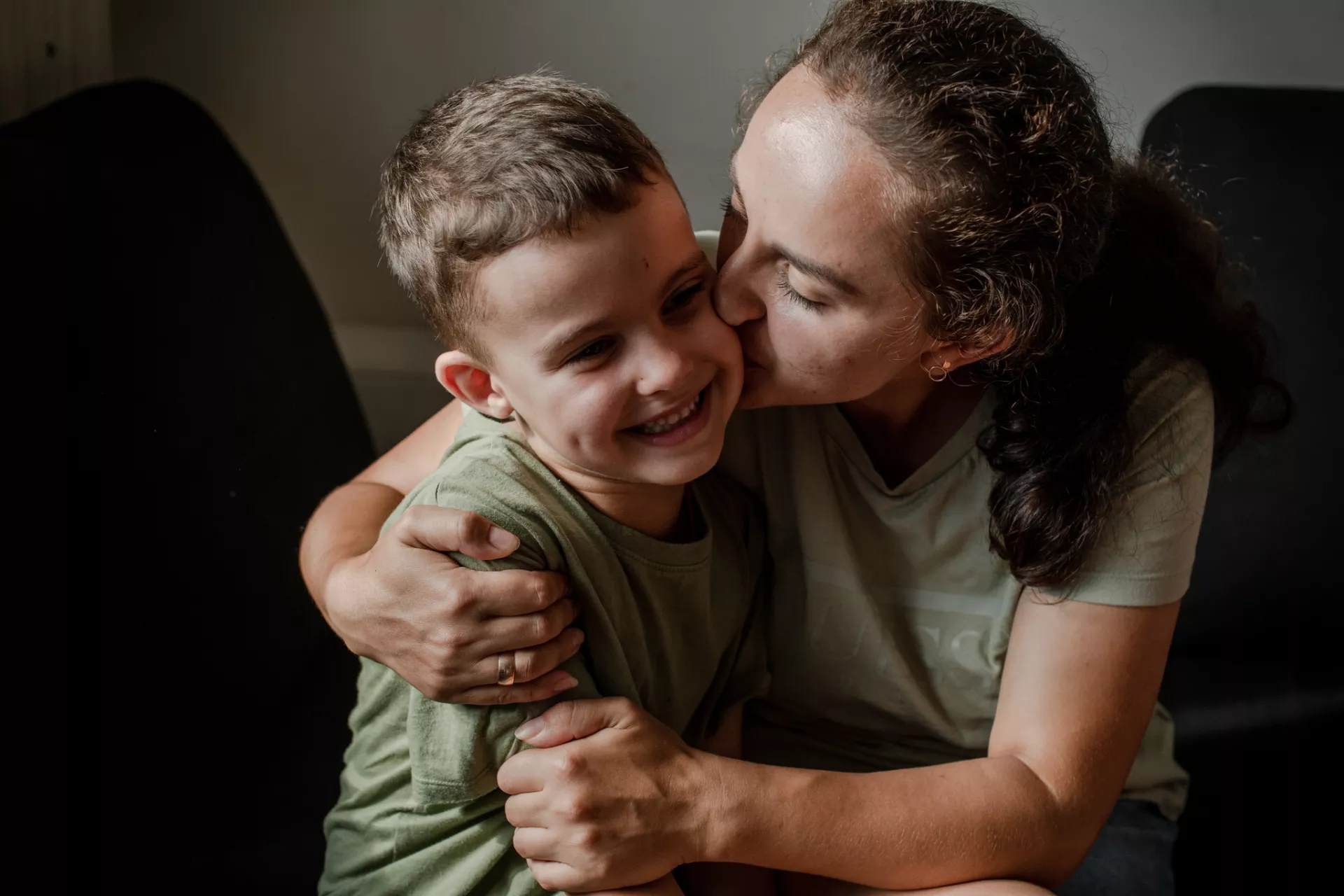 Kateryna kisses her son.