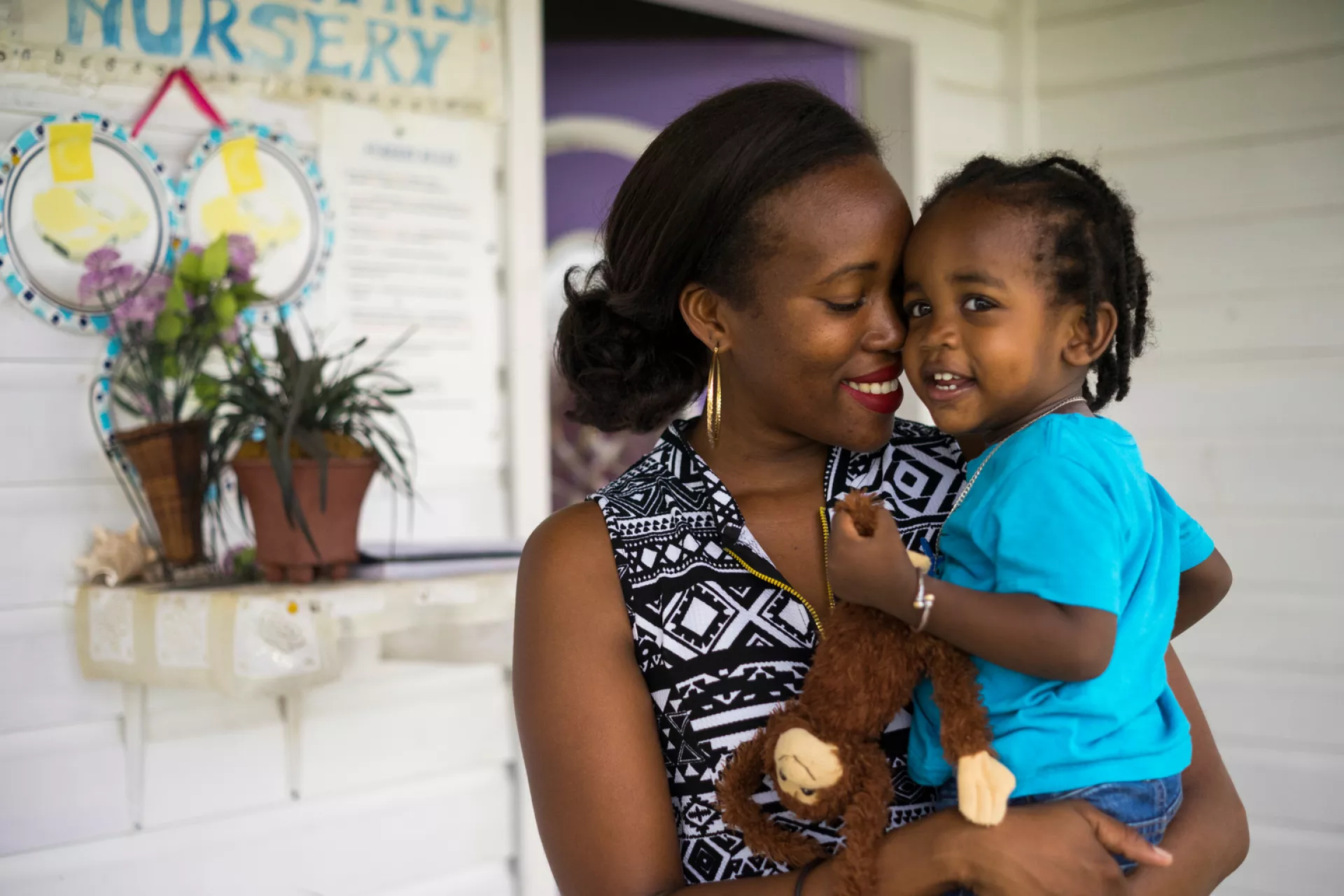 Denee Warner, 28, holds her 19 month-old son Justice Warner outside Marilyn’s Nursery in Cottonground in Saint Thomas Lowland Parish on Nevis island, St. Kitts and Nevis.