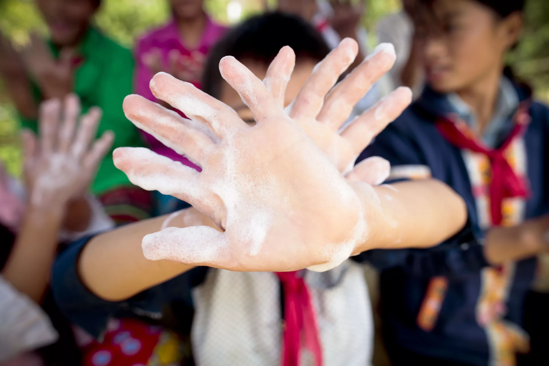 Children enjoy washing their hands with soap and clean water.