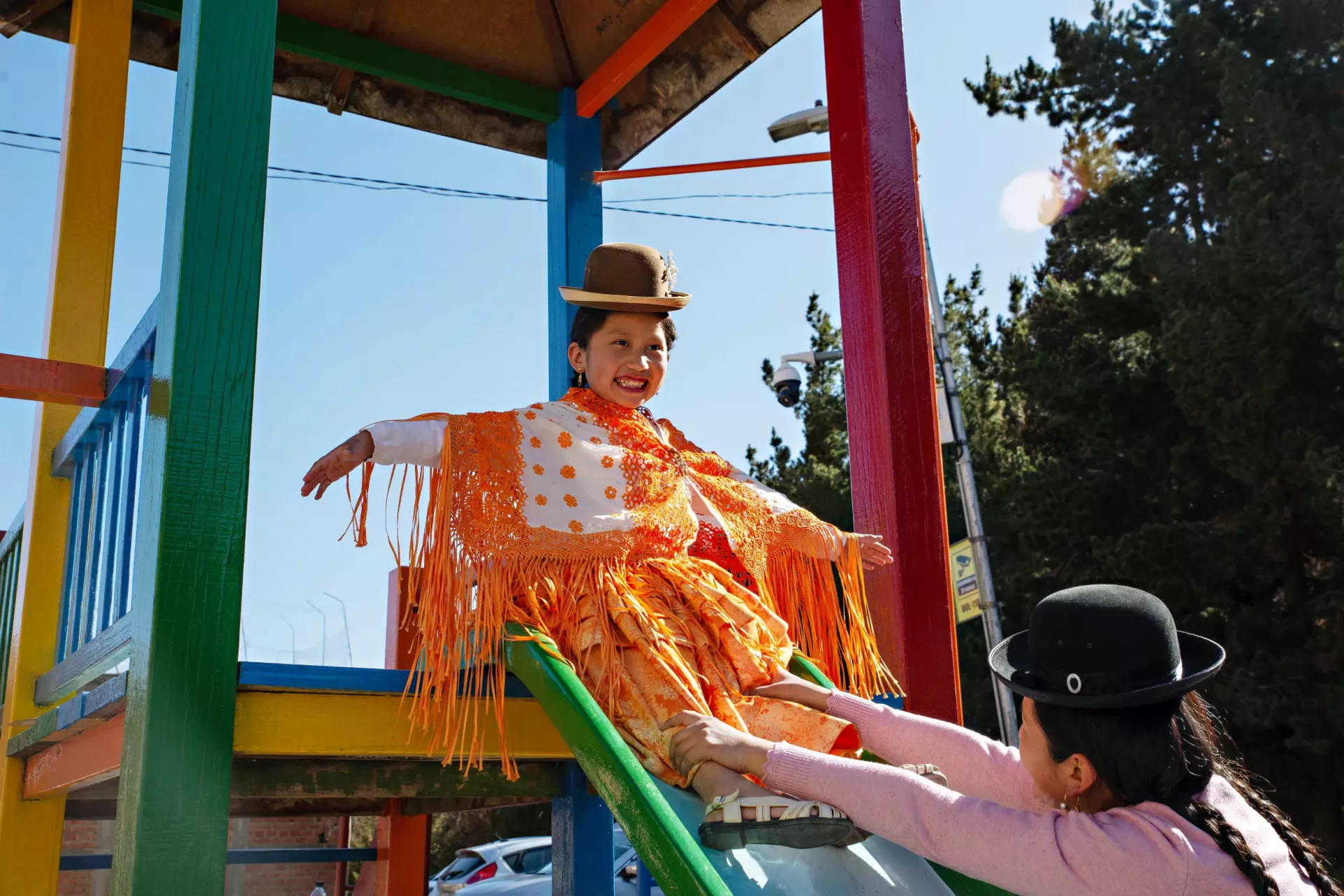 Sandra helps her daughter Nathaly, 7, down a slide at a playground in La Paz, Bolivia. 