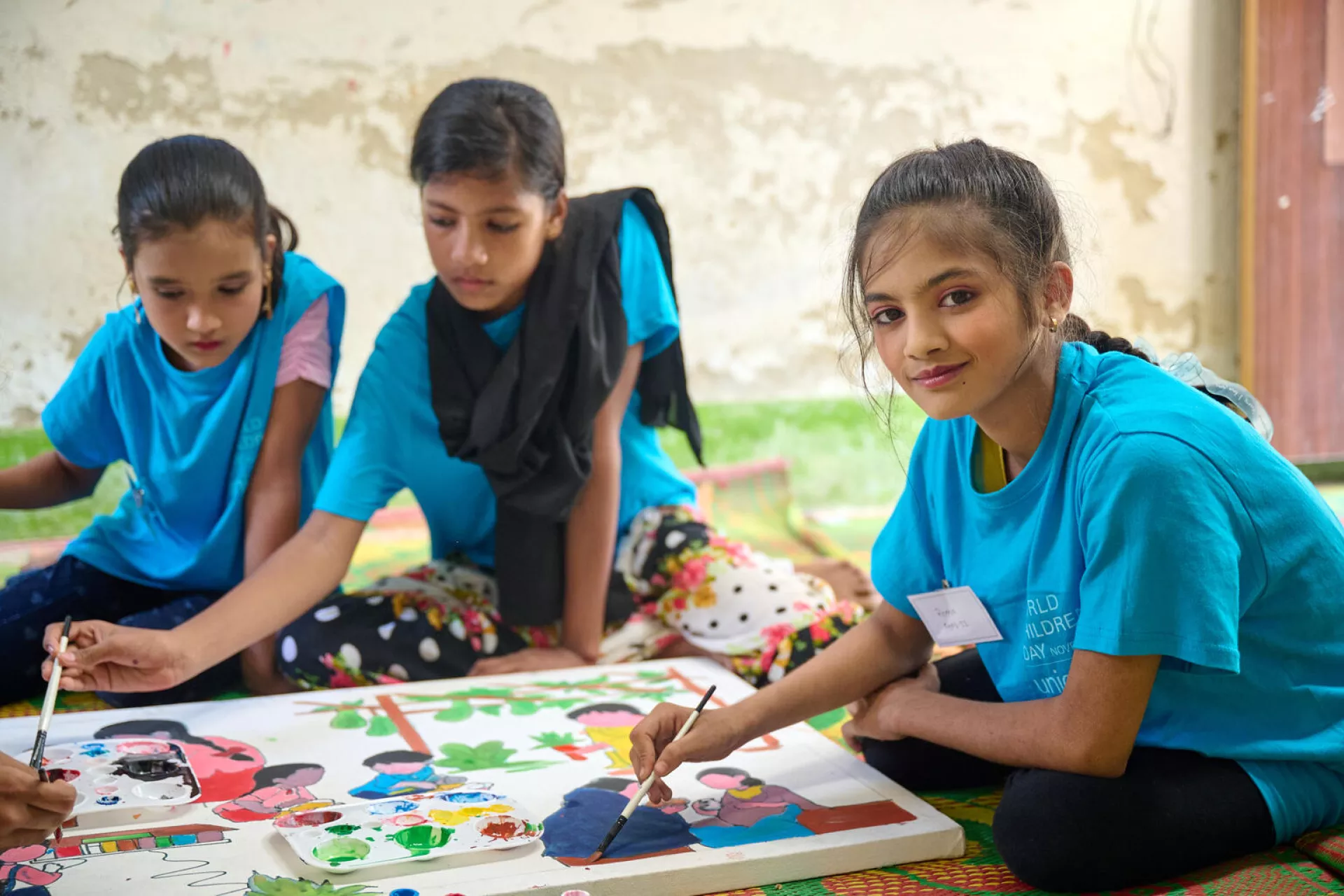Children work on a hand-painted canvas during an event marking World Children&rsquo;s Day in the Rohingya refugee camps in Cox&rsquo;s Bazar, Bangladesh.