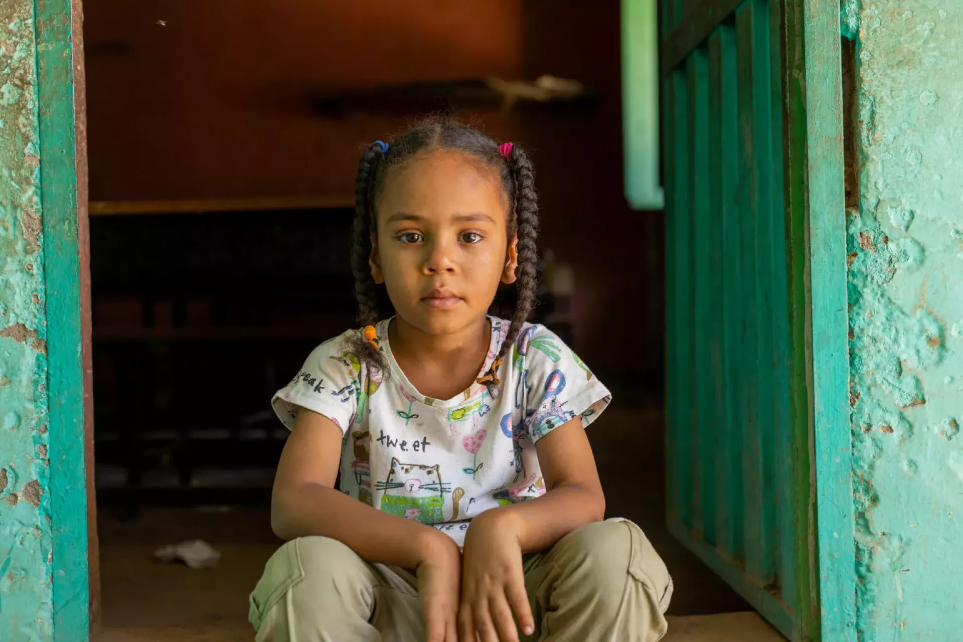 Girl sitting in doorway