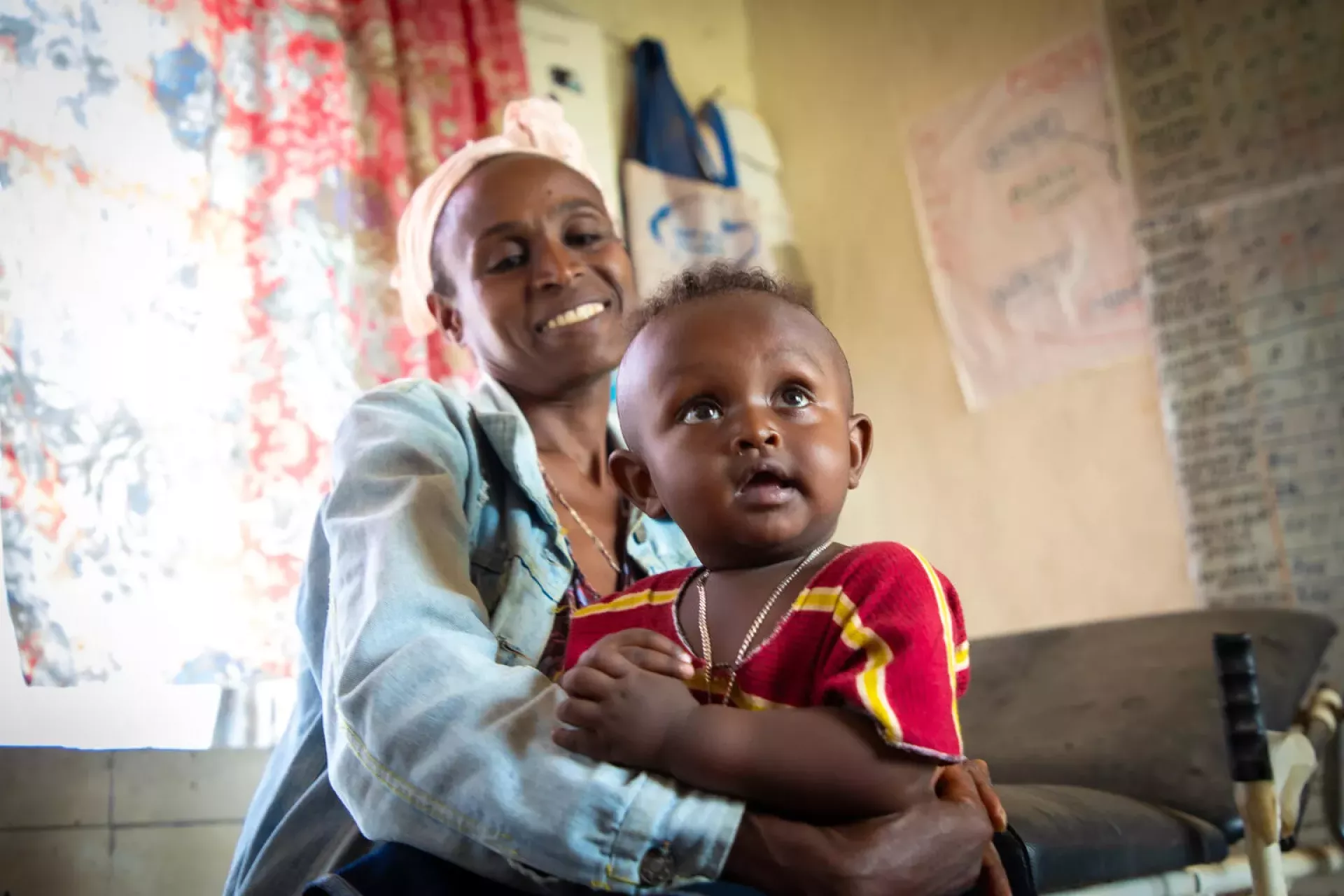 A mother holds her 8-month-old son in Ethiopia.