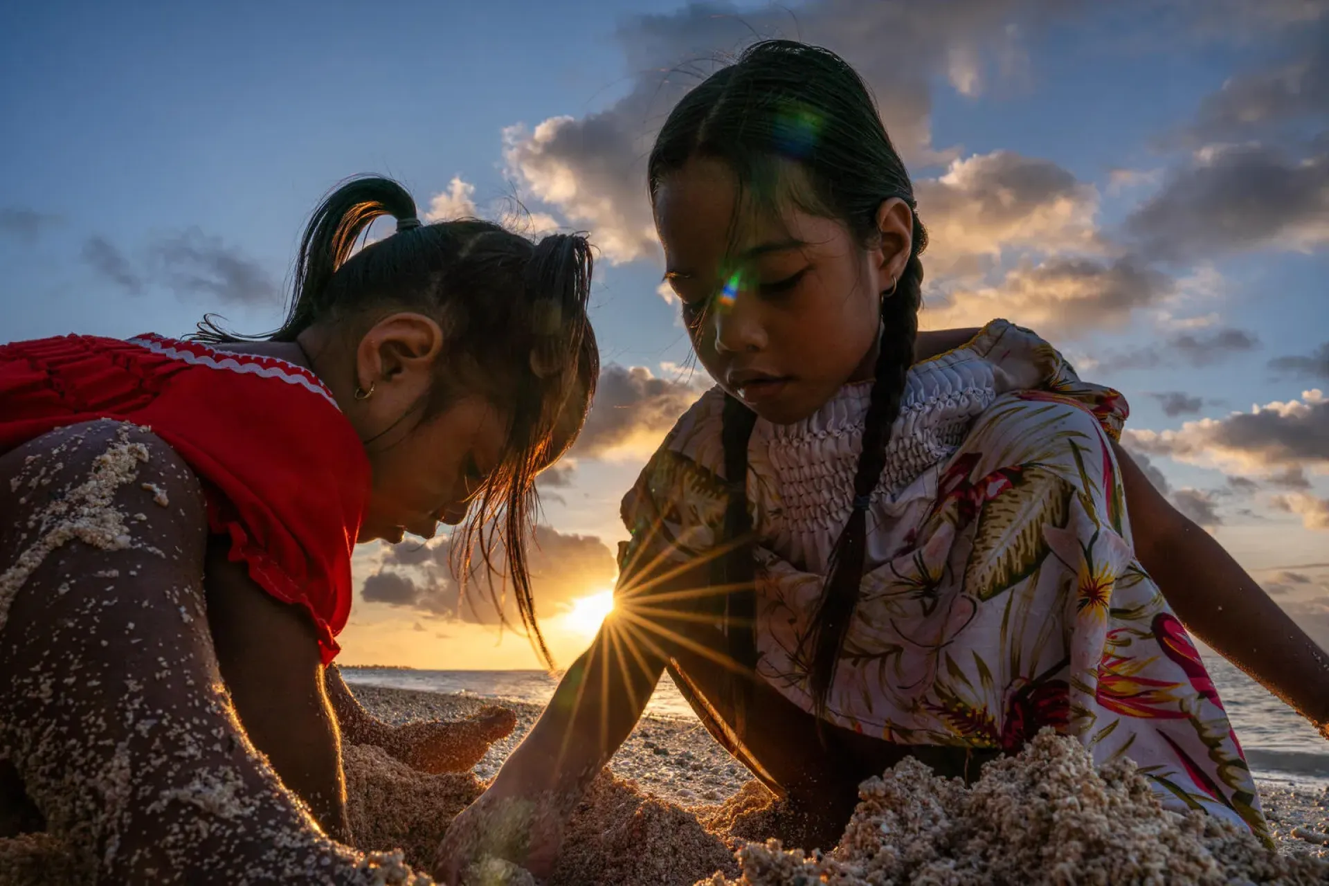 Girls play at a beach in Tarawa, Kiribati.