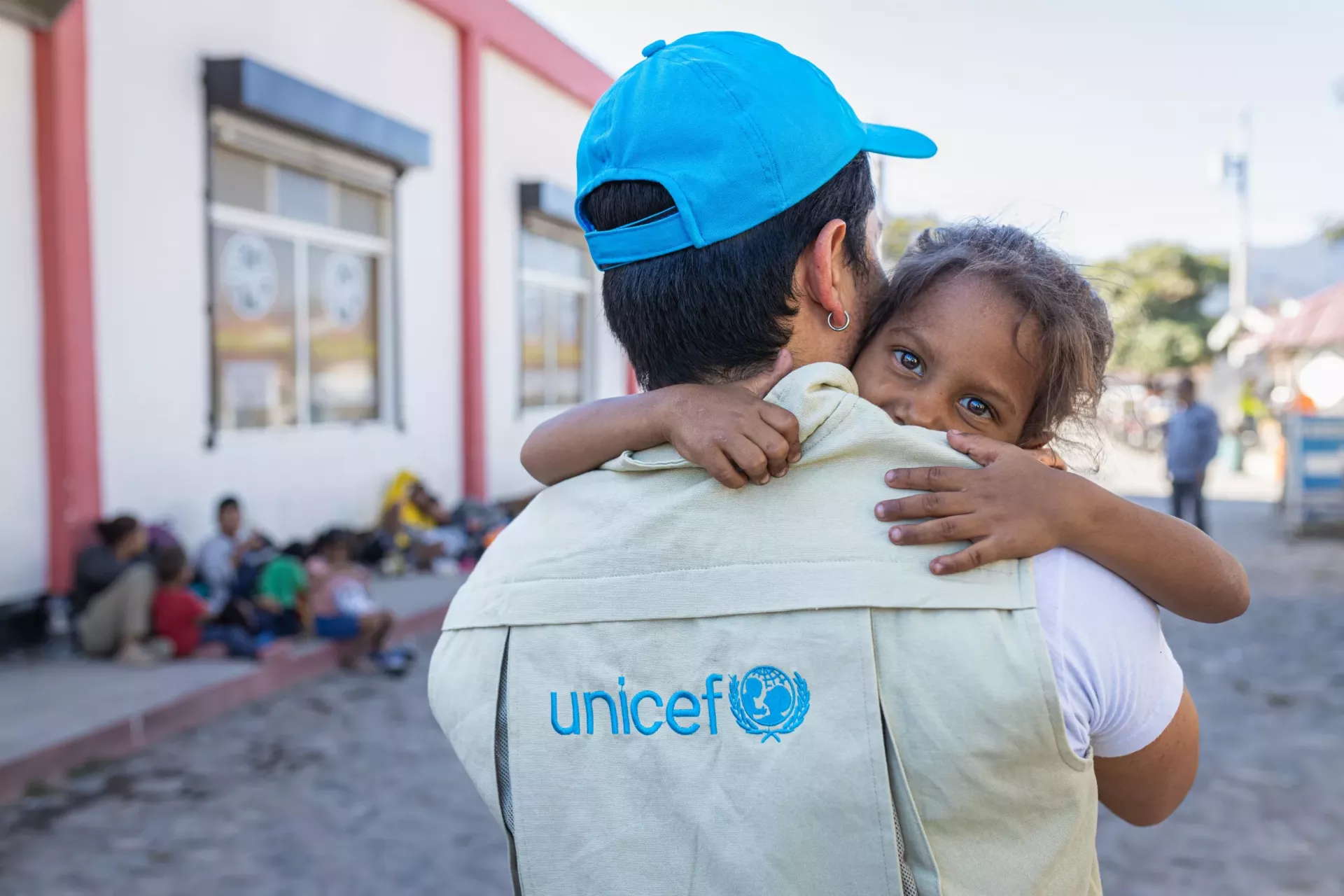 A UNICEF staff member holds a child