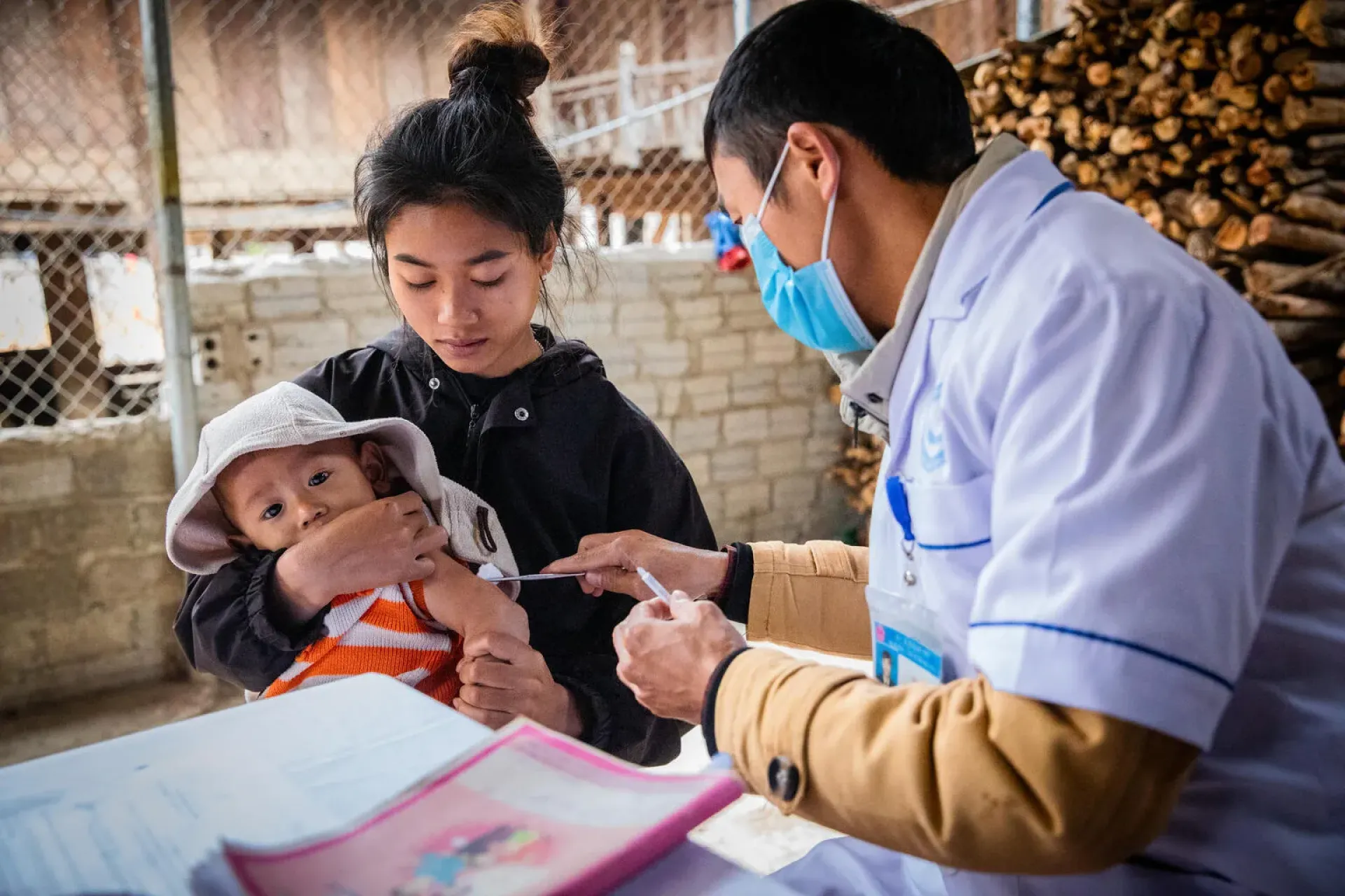 A health worker prepares to vaccinate a one-year-old child at a community centre in northern Viet Nam