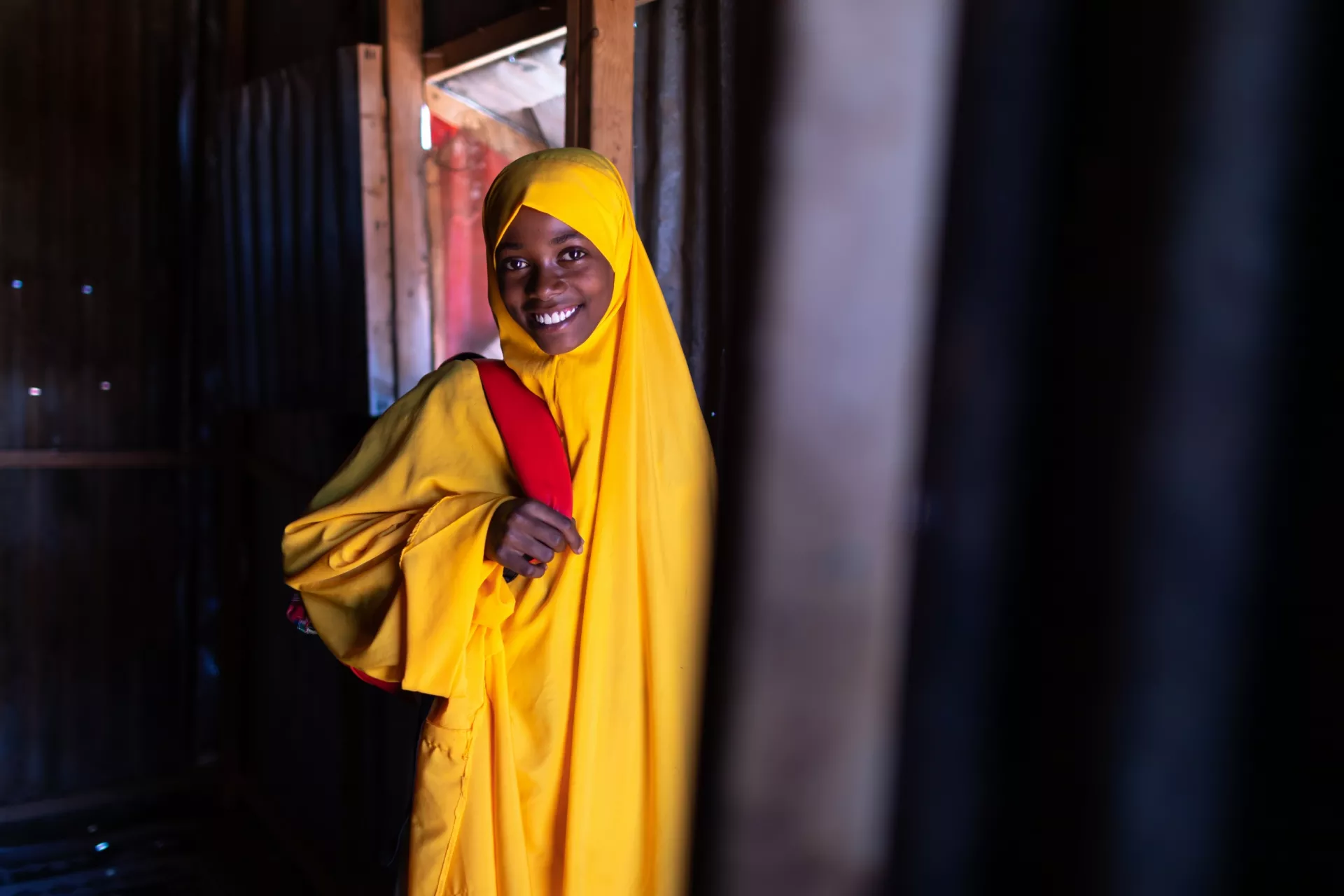 Hawa dresses in her bright yellow hijab school uniform before her half-hour walk to Mustaqbal School in Xaar-Xaar, Somalia