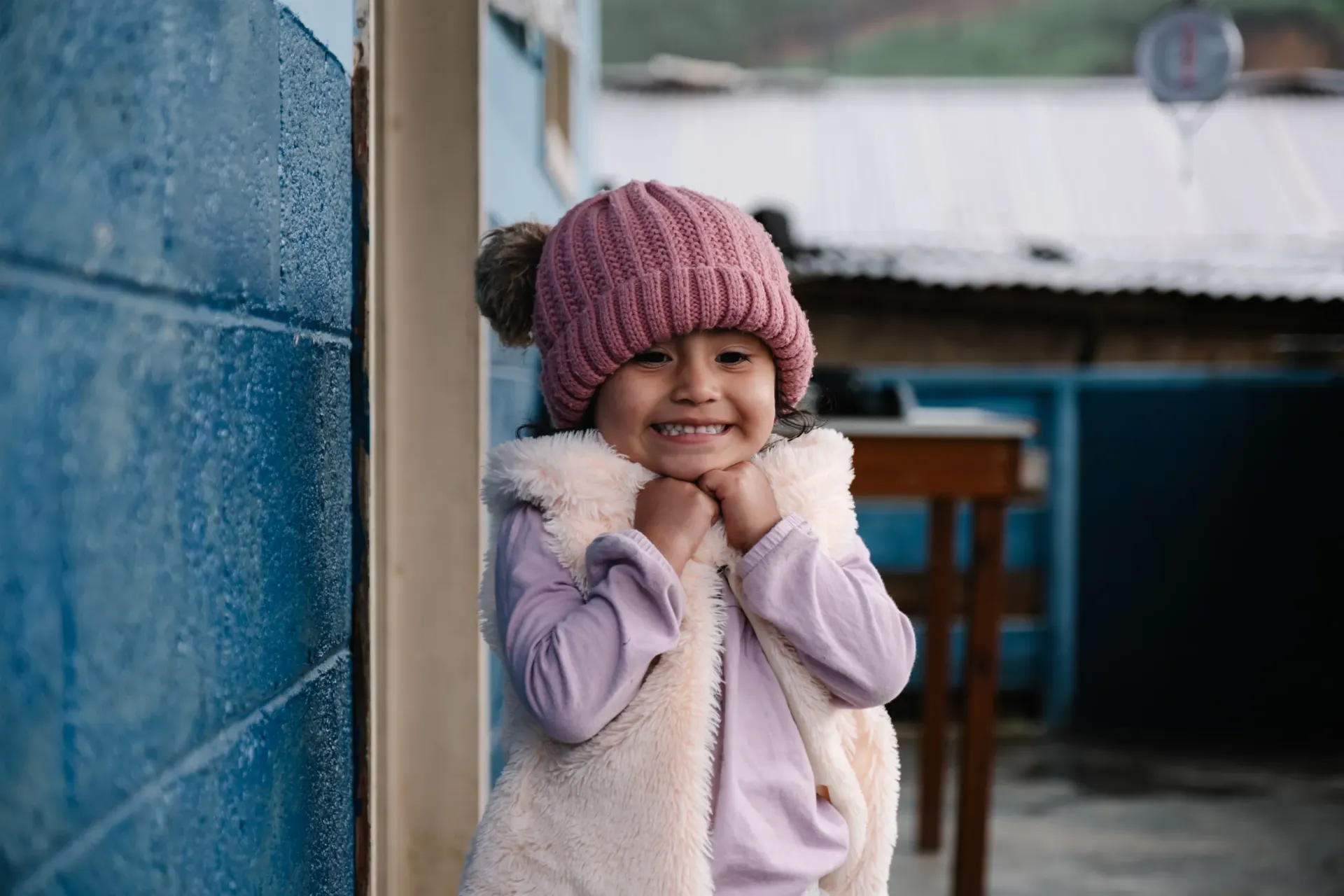 3 year old Amani smiles outside the local health center in Chiretzaaj, Cob&aacute;n, Guatemala.