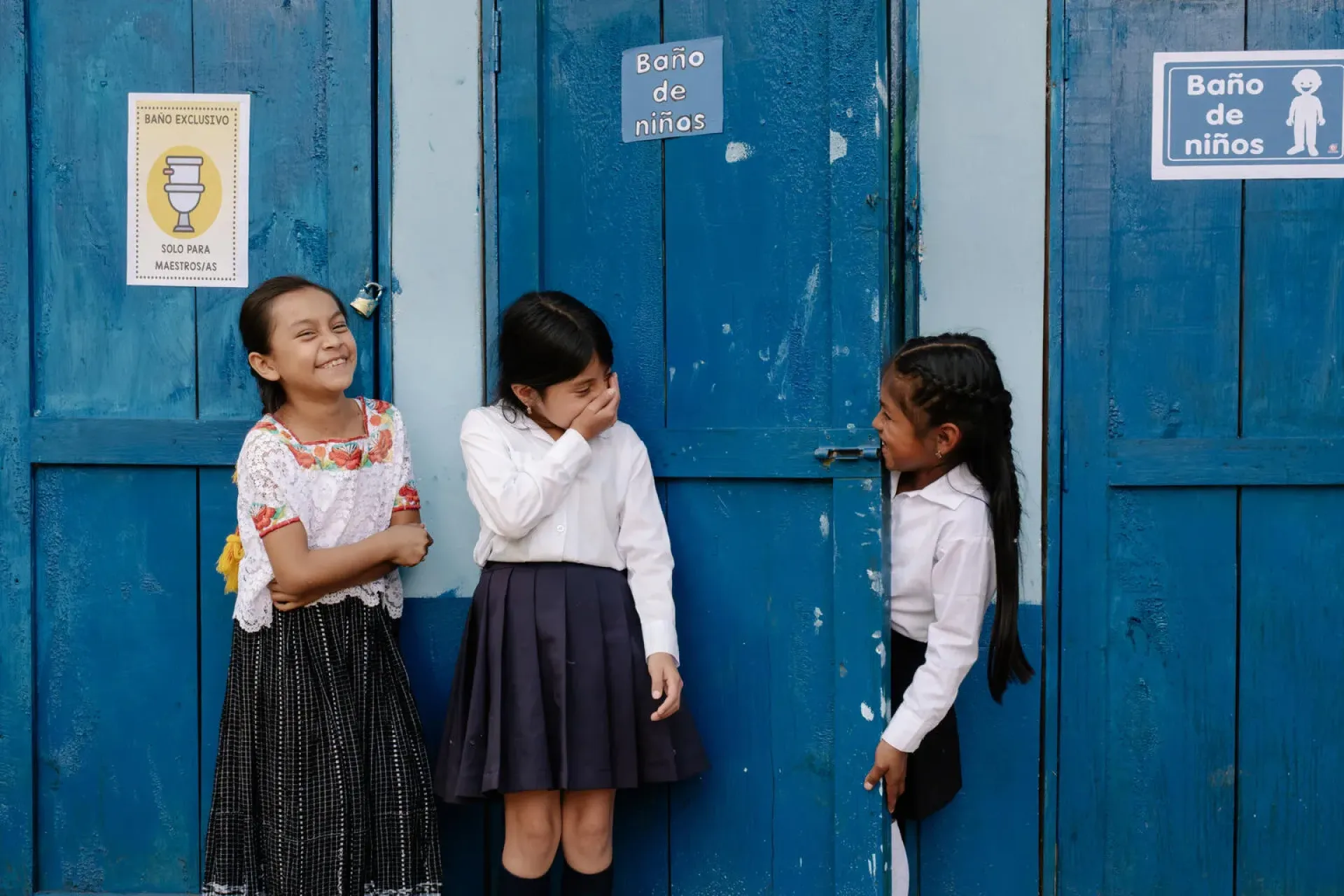 Karen, Vilma and Rosita stand outside the bathrooms at their school in Guatemala, where a UNICEF-supported Clean Hands Festival helped children learn about hygiene and handwashing.