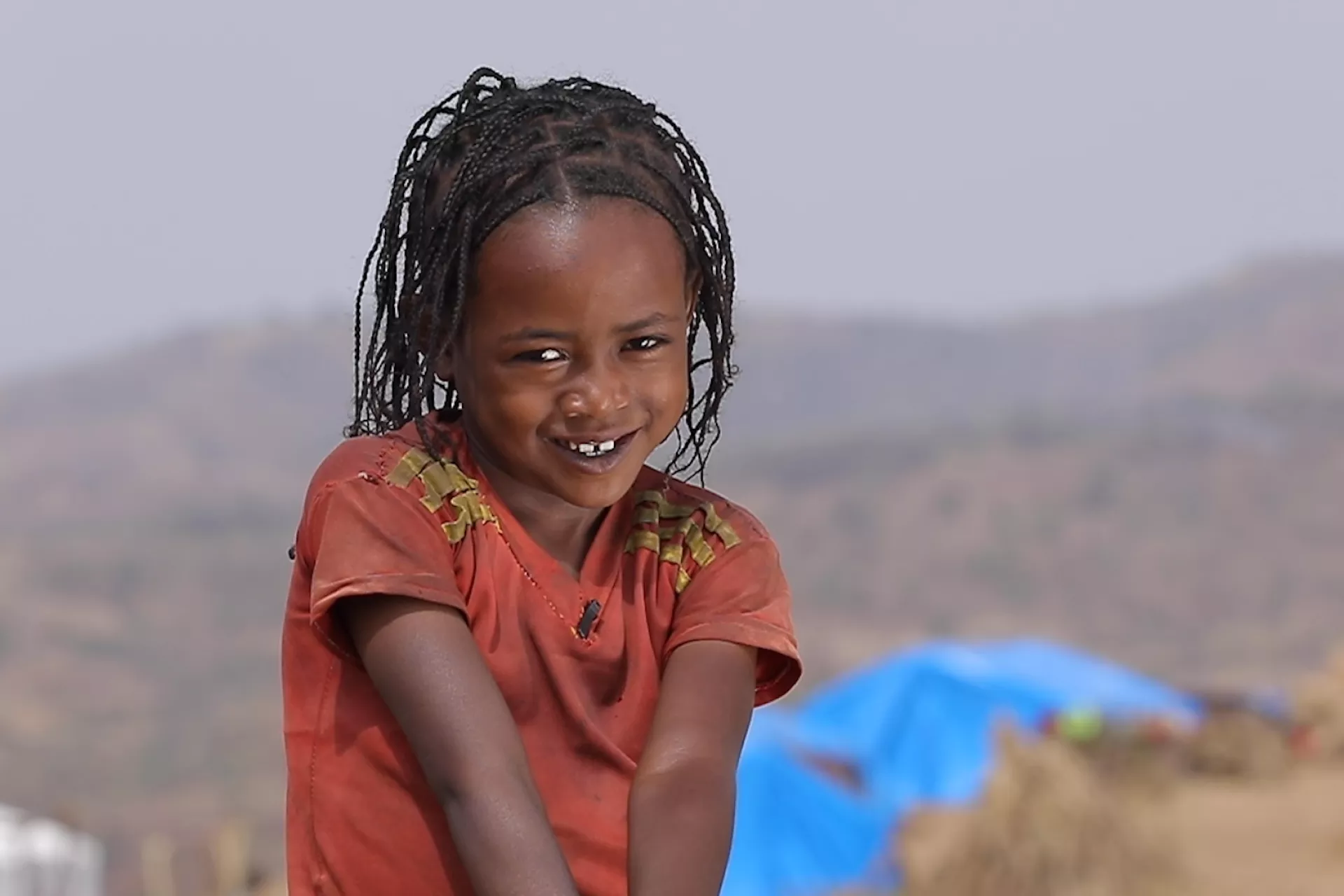 Ethiopia. A girl smiles at the camera.