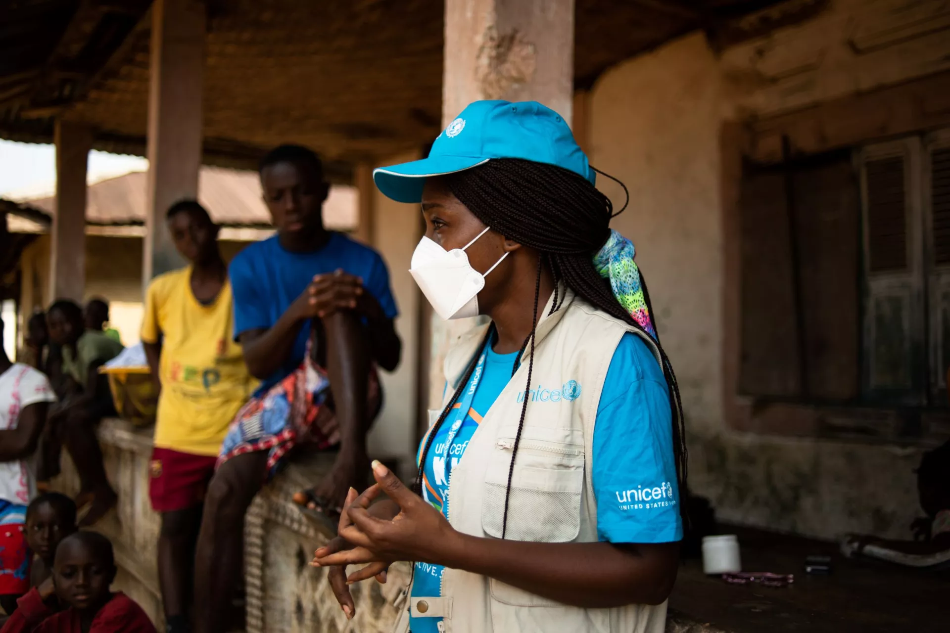 Liberia. A UNICEF health worker talks to people in a village about the polio vaccine.
