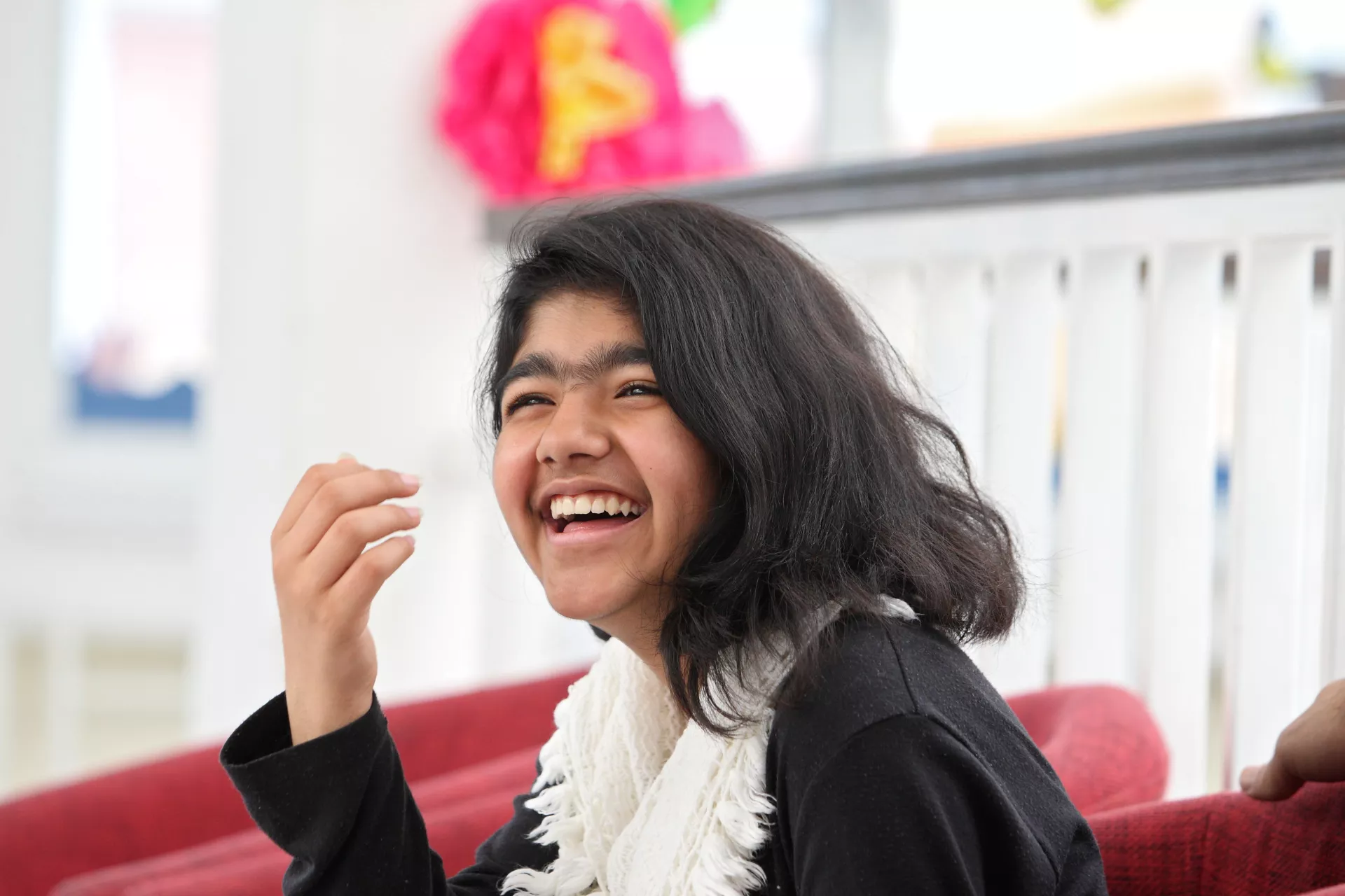 An Afghan teenage girl laughing