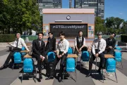 A group poses in front of a sign that reads &amp;quot;#BTSLoveMyself&amp;quot;