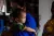 An infant child gazed outside from her mother's shoulder