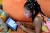 A seven-year-old girl in Côte d'Ivoire studies at home on a tablet device in 2020.