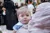 Syria. A baby looks over her mother's shoulder mother as they wait for a medical checkup at a UNICEF-supported clinic.