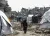 Gaza Strip. Children walk past tents in Jabalia camp.