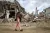 Gaza. A girl walks past the rubble of her destroyed neighborhood in Khan Younis.
