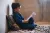 Syria. A boy sits on the floor reading at his home in Zabadin, Rural Damascus.