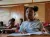 Haiti. A girl sits at a desk in a classroom.