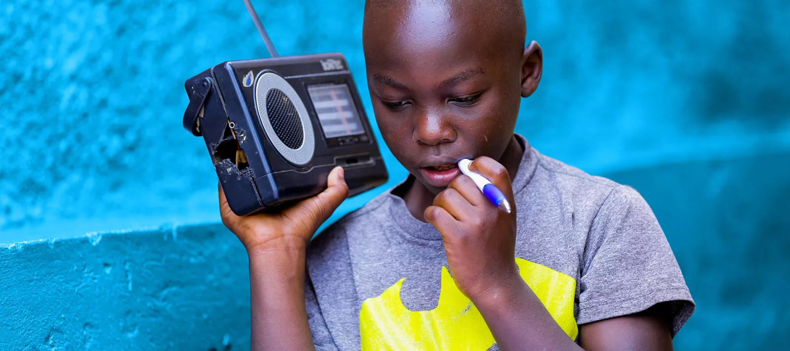 Igihozo Kevin, 11, studies at home due to coronavirus-related school closures, listening to his Primary 5 lessons on the radio every day.