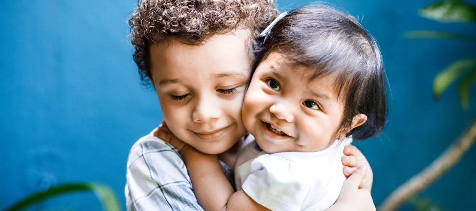 On October 5th, 2021, David Emanuel Setma Urzia (4 years old) hugs his sister Ana Elizabeth Setma Urzia (1 year old) in the garden of their home in Guatemala City.