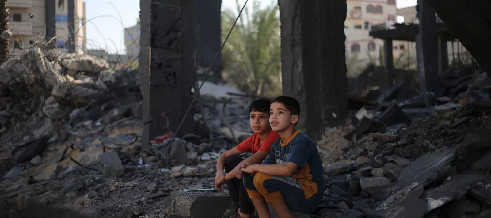 Two Palestinian children sitting in the rubble of what is left of their house in Rafah city, southern the Gaza Strip.