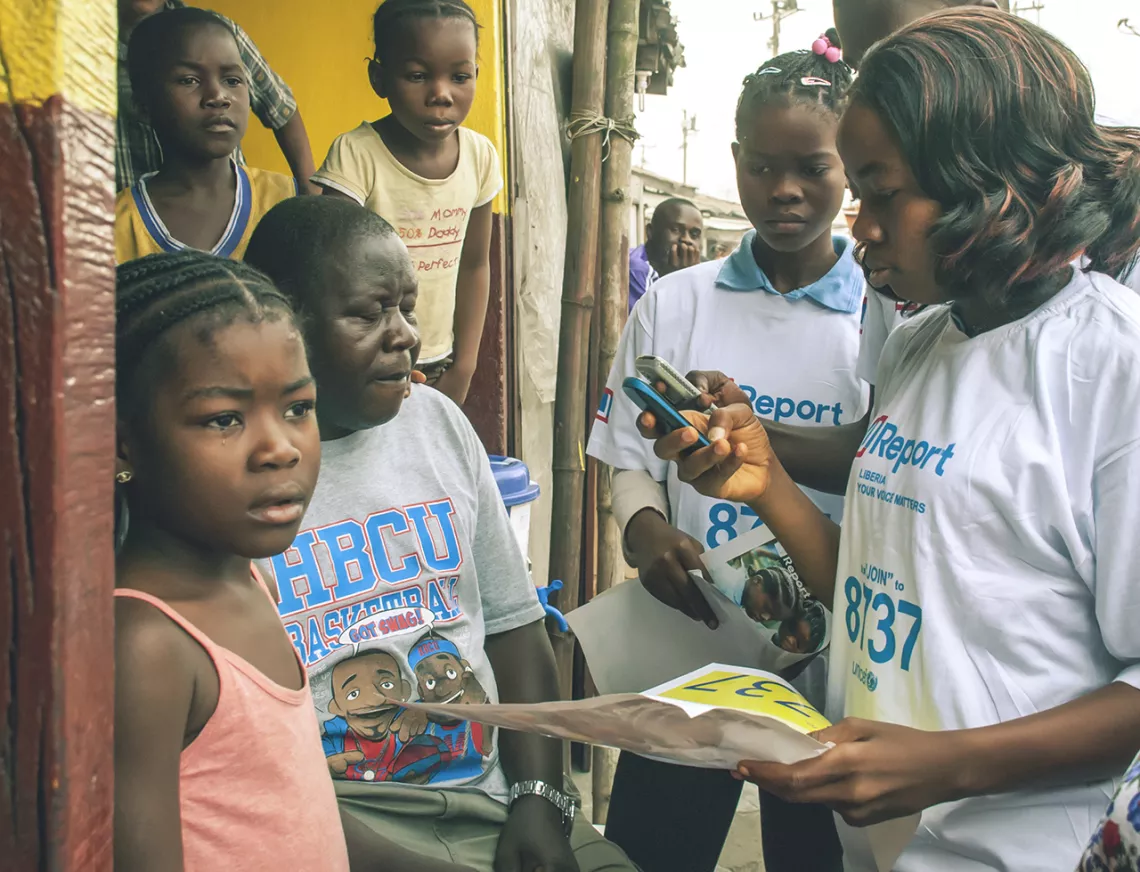 Adolescent girls read text messages.