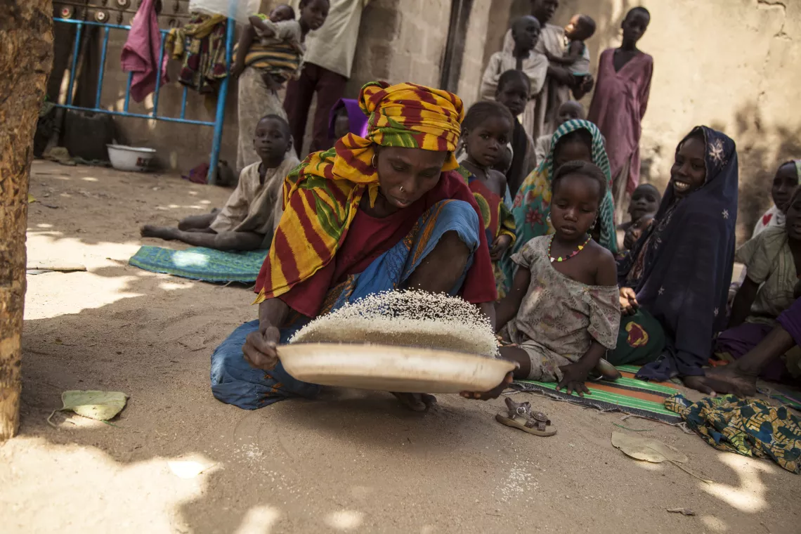 A woman sorts rice.