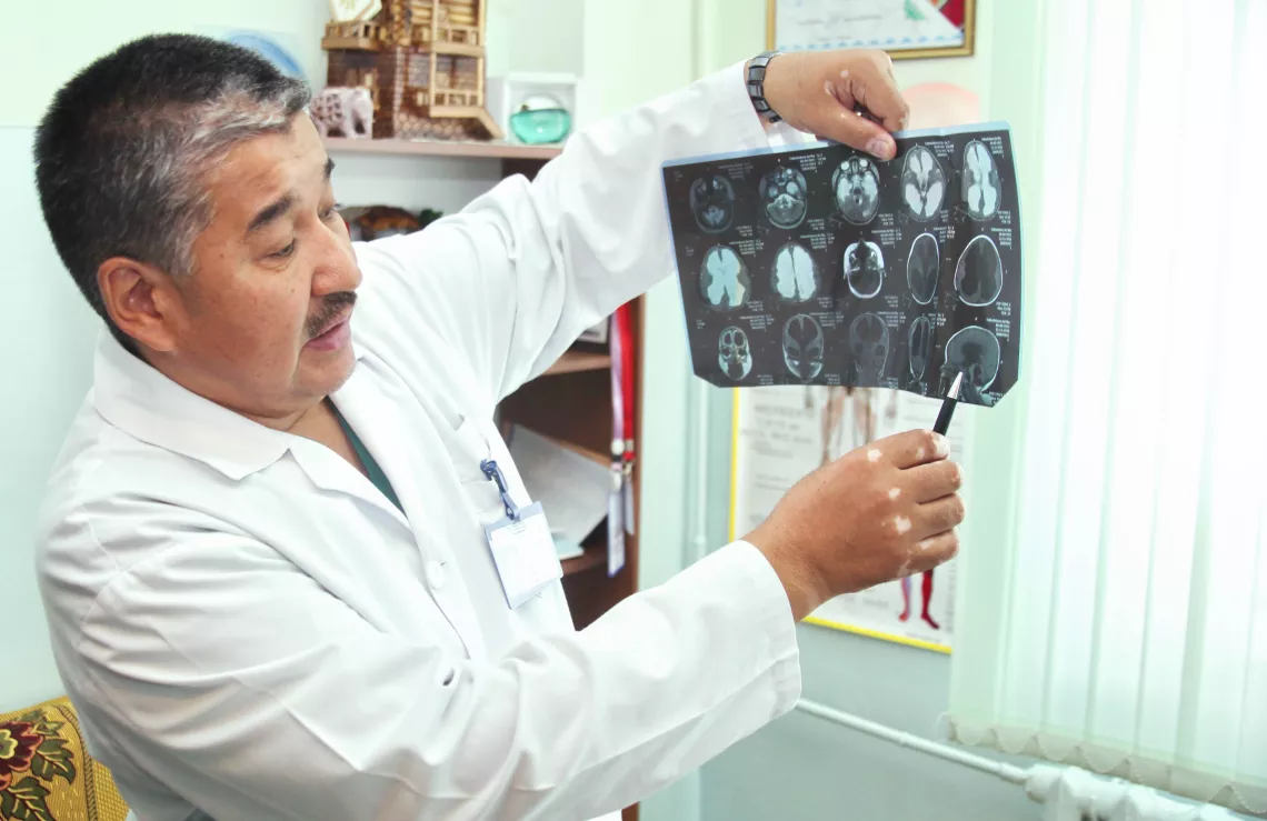 A doctor examining images of a child's brain