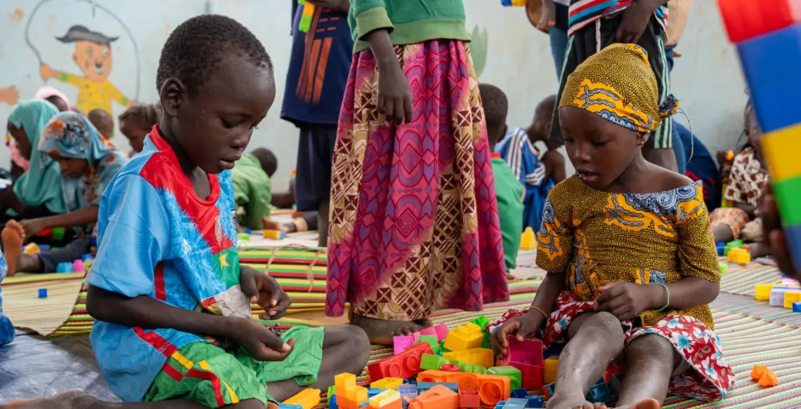 Children playing on the floor in a play space