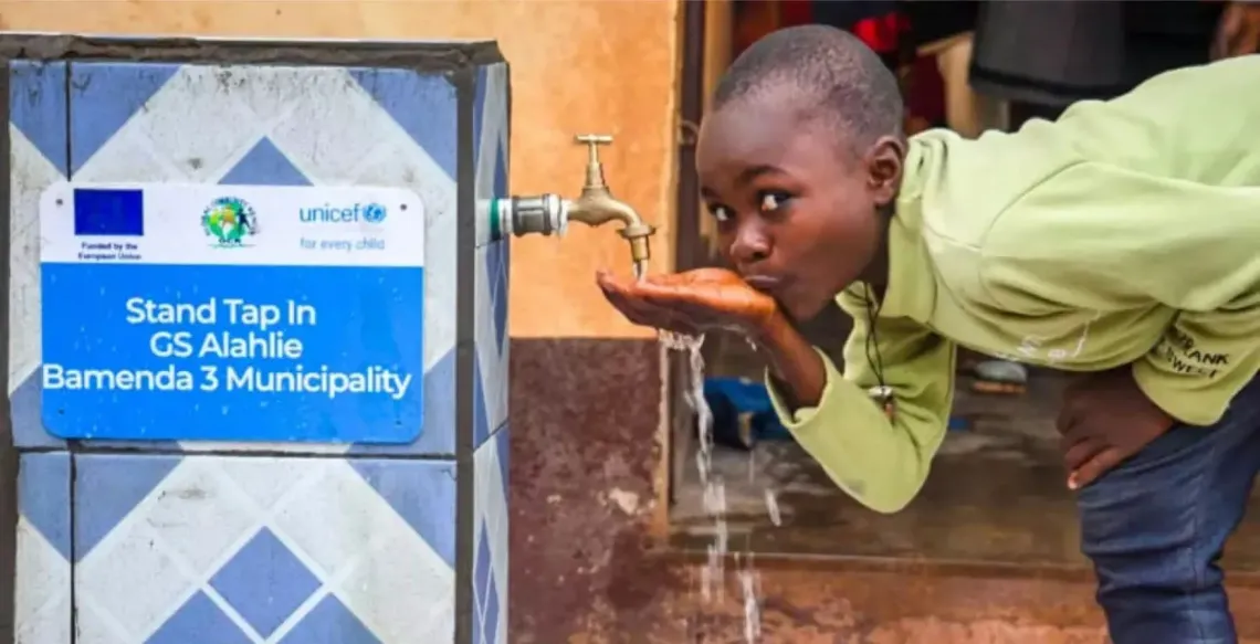 A child drinks from a tap